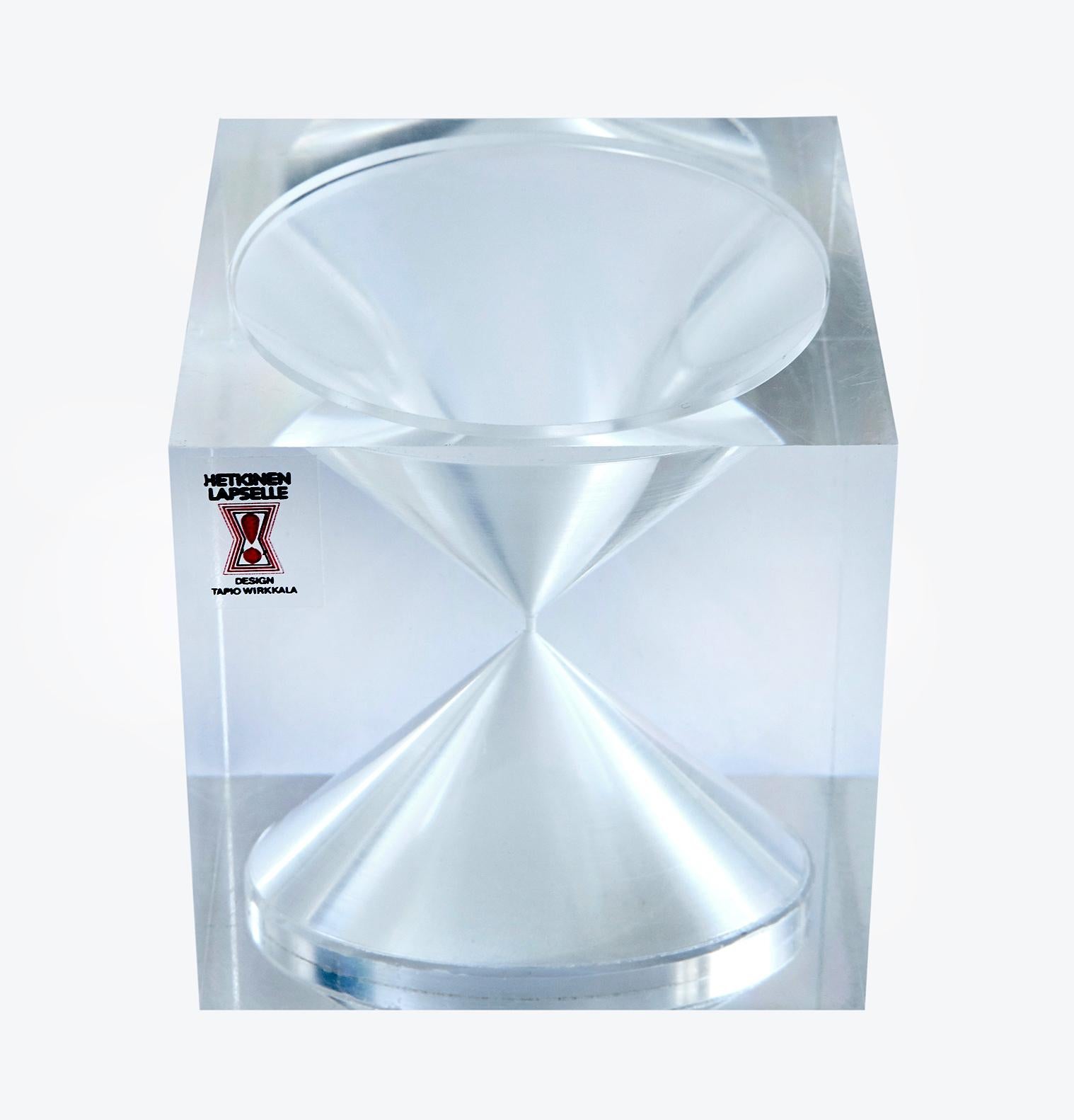 In the mid-1960s a small number of these exquisite hourglass cubes -- designed by Finnish design legend Tapio Wirkkala -- were made with great precision of clear acrylic and white sand to raise money for the Mannerheim League for Child Welfare. The