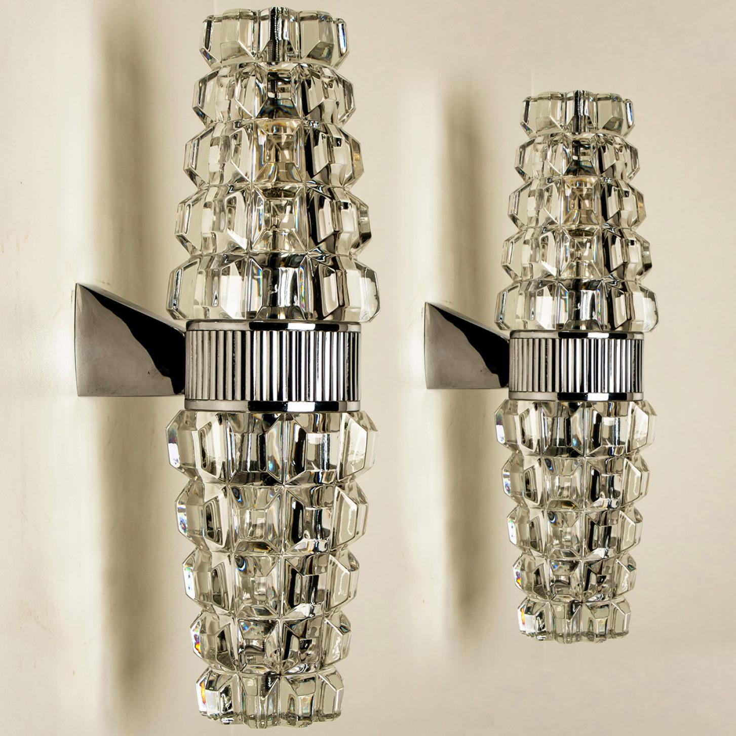 High-end wall sconces, made in France, Europe, around 1970. The wall lights are made of lead crystall and a chrome frame holding the glass.

Dimensions:
Height: 13.78 inch (35 cm)
Width: 3.94 inch (10 cm)
Depth: 5.9 inch (15 cm)
Please notice the
