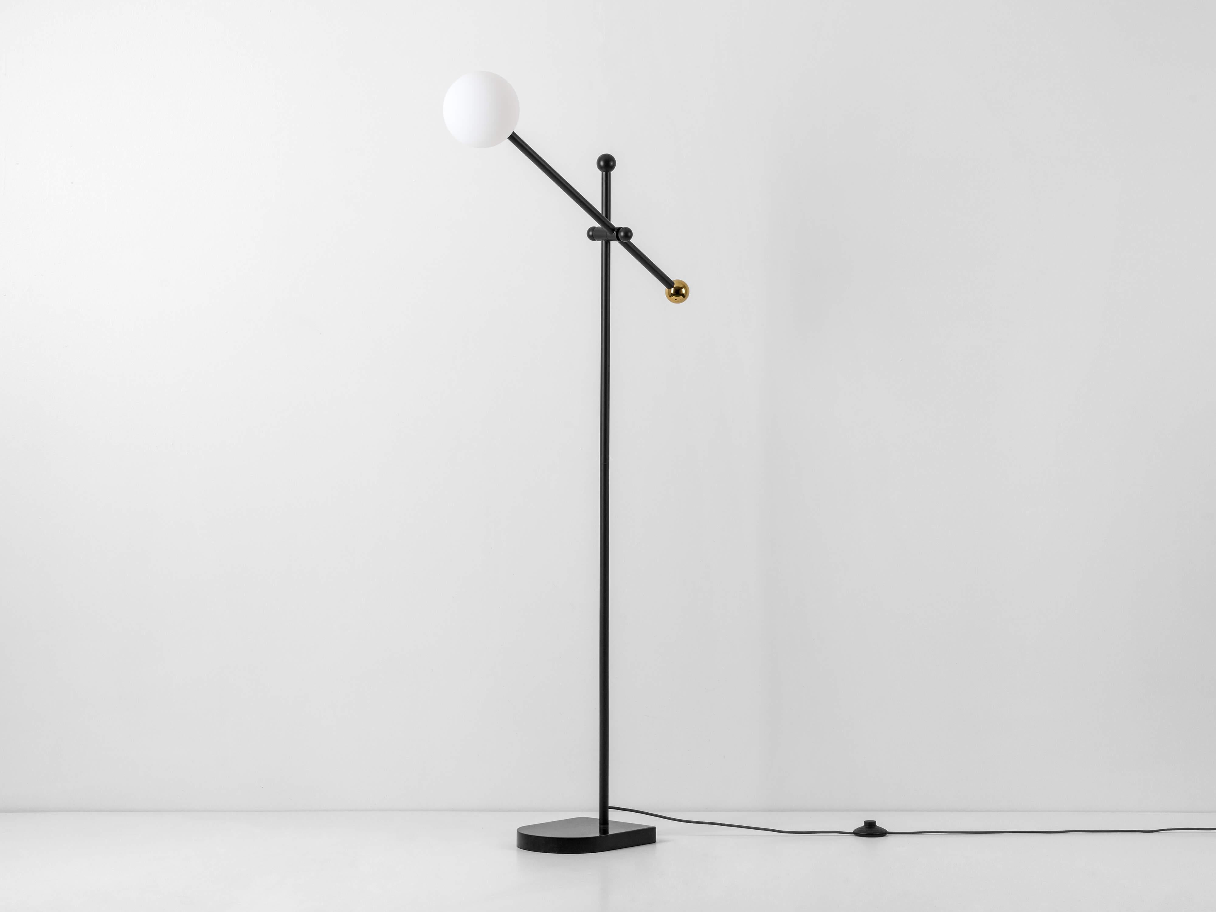 With a solid black marble base and gold detailing, this standing floor lamp is the epitome of sleek sophisticated luxury. The lamp can be angled to cast light wherever you need it - perfect for working, reading or even illuminating a dining table.