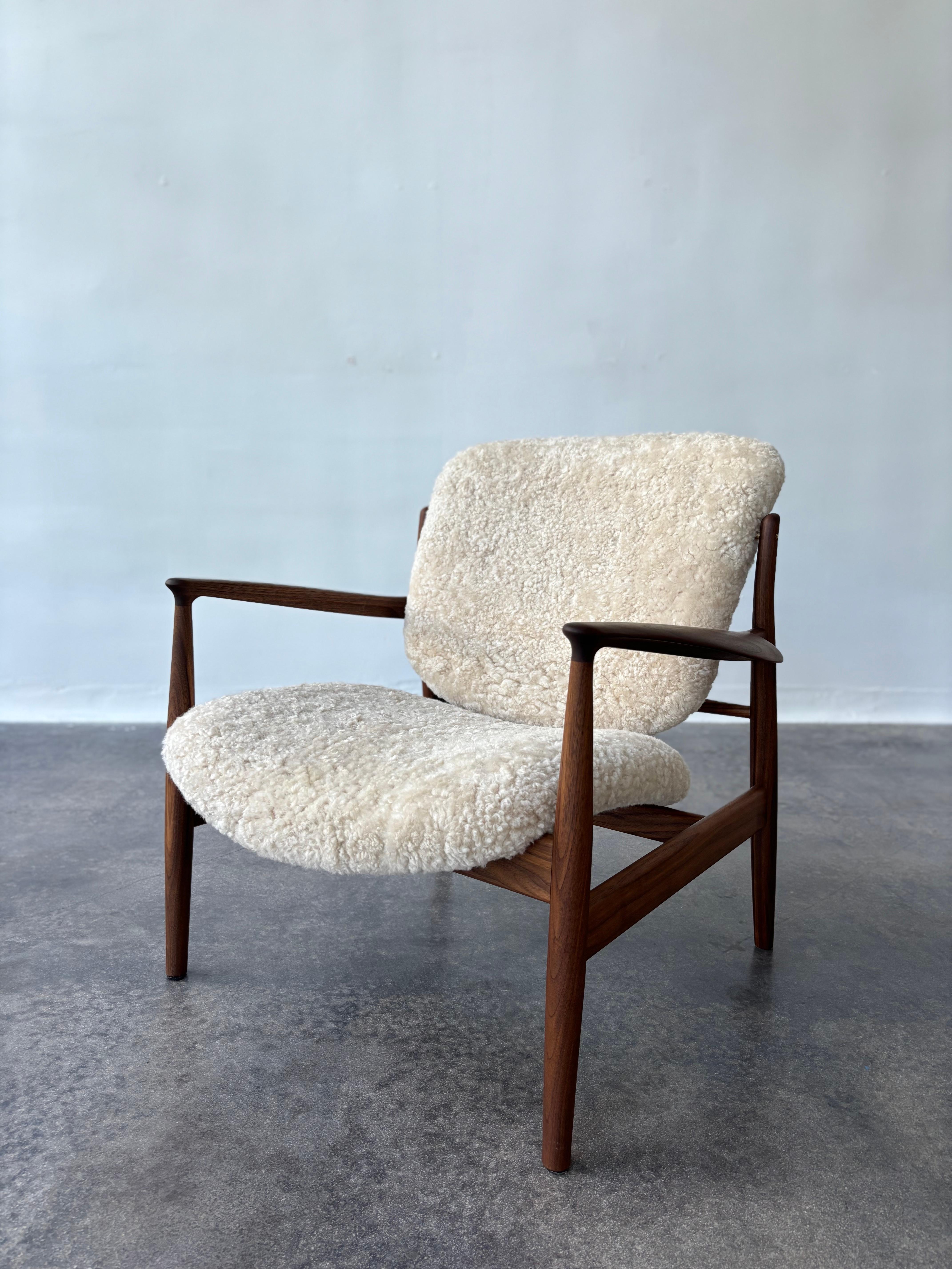 The iconic France Chair by Danish master Finn Juhl was designed for the American market in 1956 and is recognized by its fine details; the seat and back are lifted from the frame while the armrests have the iconic paper knife detail. We are a Miami,