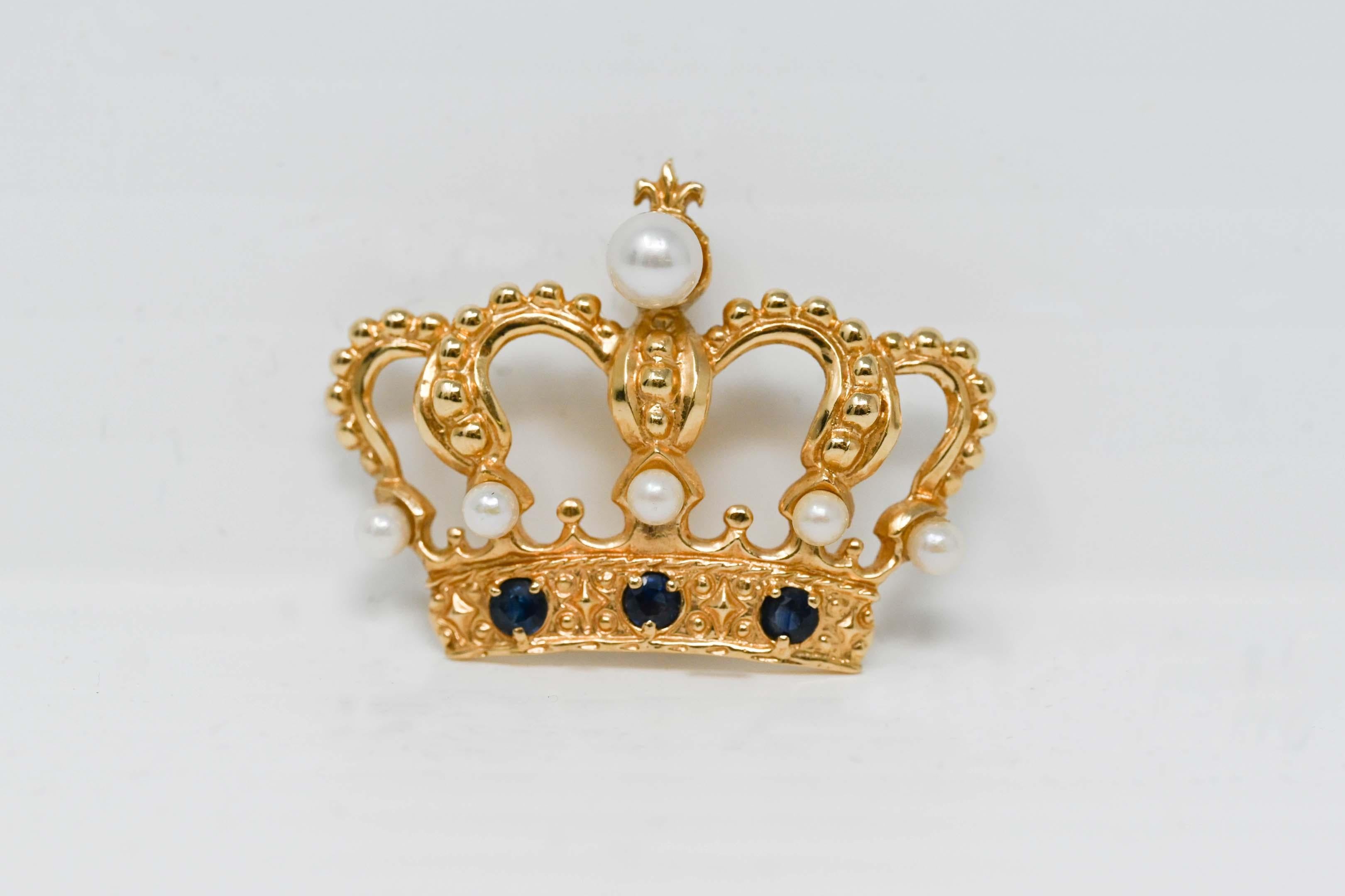 1982 14k gold brooch crown by House of Igor Carl Faberge for Franklin Mint. Fully marked on the back. Decorated with pearls and sapphire gemstone, measures 23 x 30 mm. Weighs 5.4 grams.
