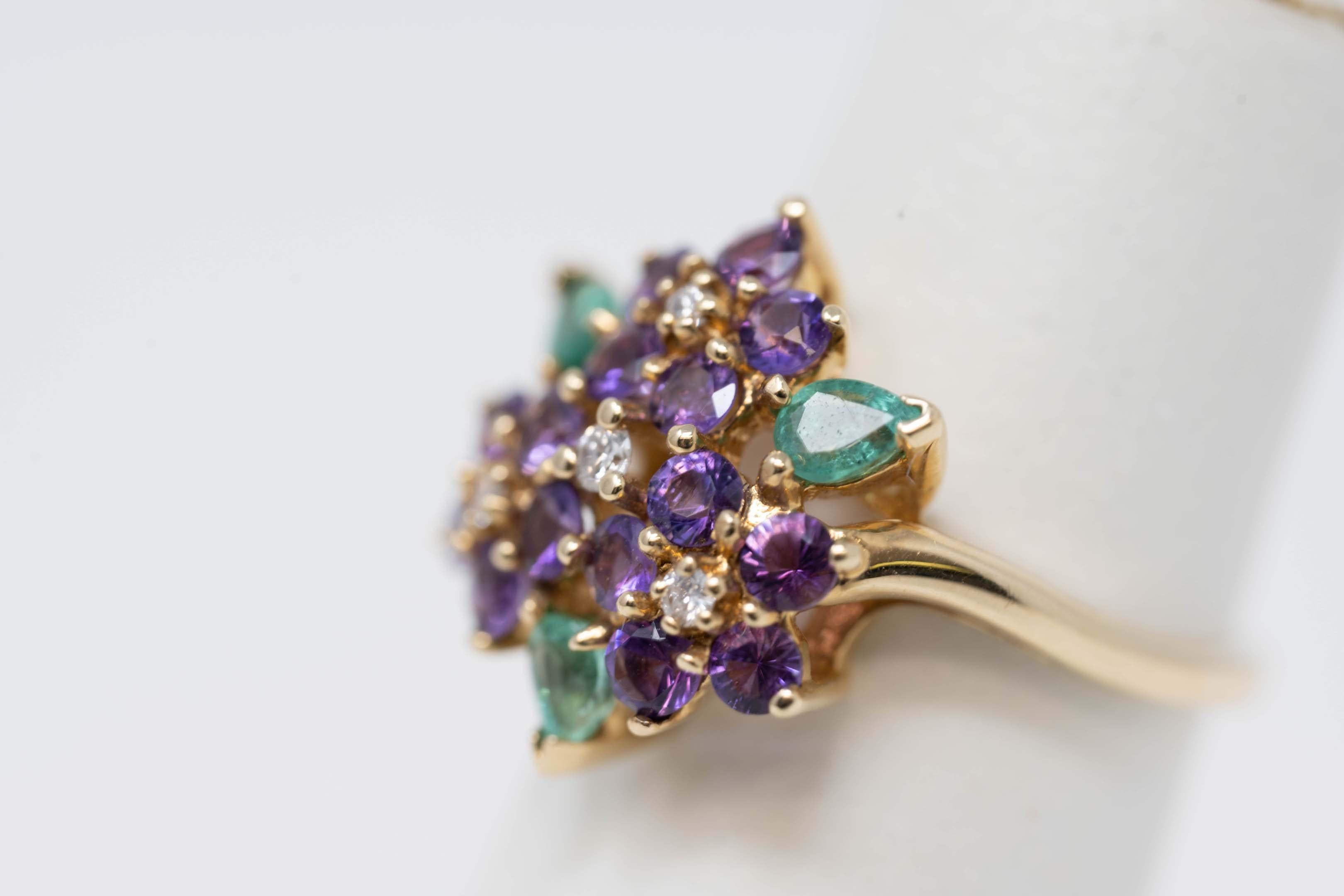 House of Igor Carl Faberge for Franklin Mint 14k yellow gold ring, size 5 1/2. With 4 diamonds, 3 pear shaped emeralds and 15 amethyst gemstones. Stamped inside 92-FM and Faberge mark. Weighs 4.3 grams.
