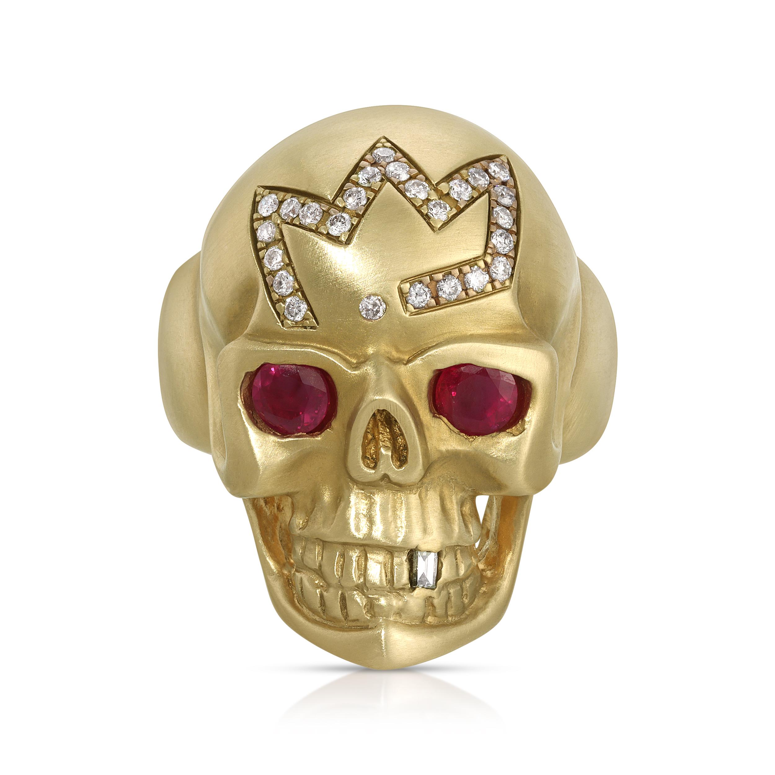 14k yellow gold, hand carved large skull ring, with ruby eyes, diamond crown, and tooth

31 grams of 14k yellow gold with ruby eyes, a pave diamond crown, a baguette diamond tooth, and a small accent diamond hidden inside the band.