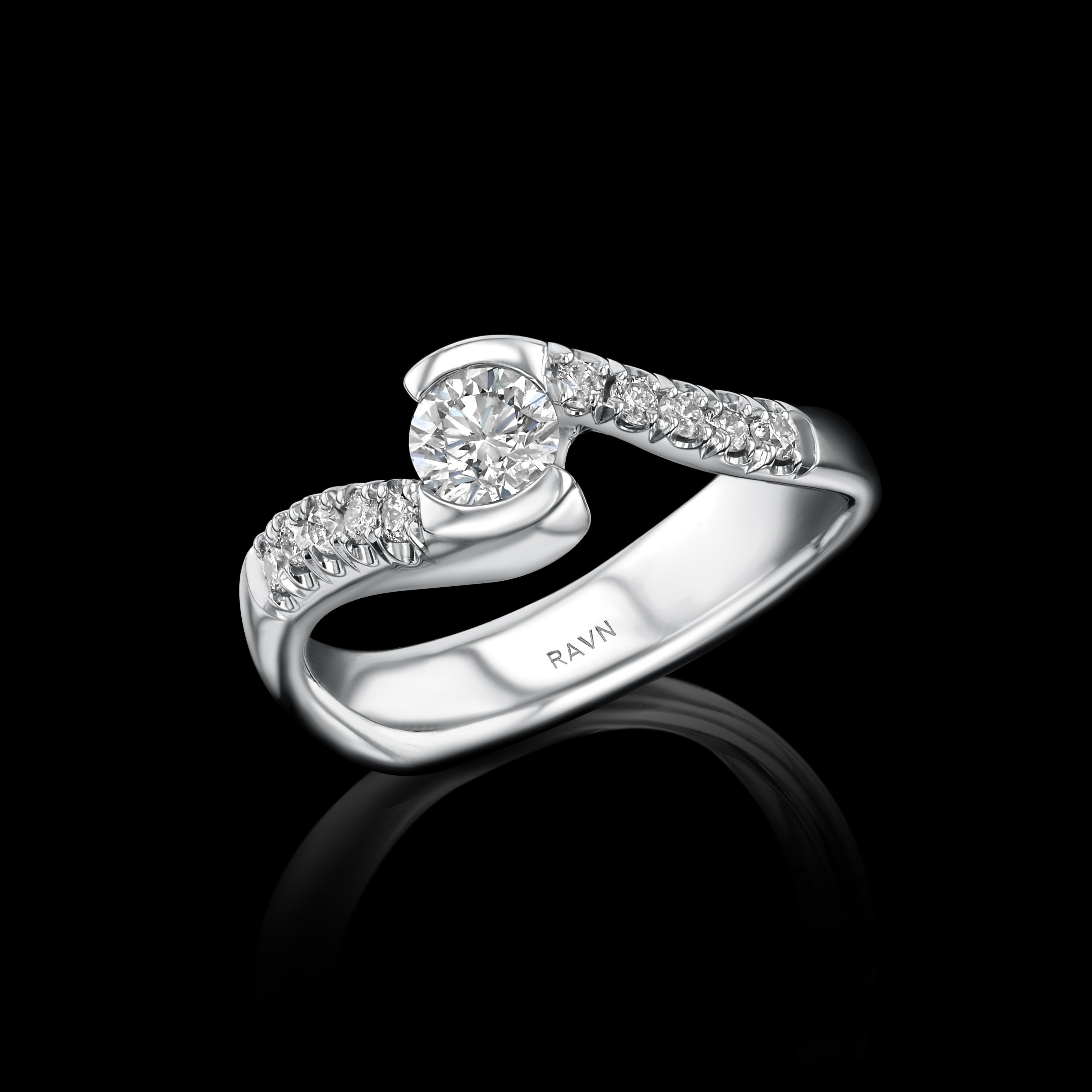 18k white gold, hand carved twist half bezel diamond ring, with .35ct center diamond and 10 shoulder diamonds (0.10ct) from the House of RAVN Diamond Collection.   

Features .45ct total diamonds.    



The House of RAVN Diamond Collection is as an