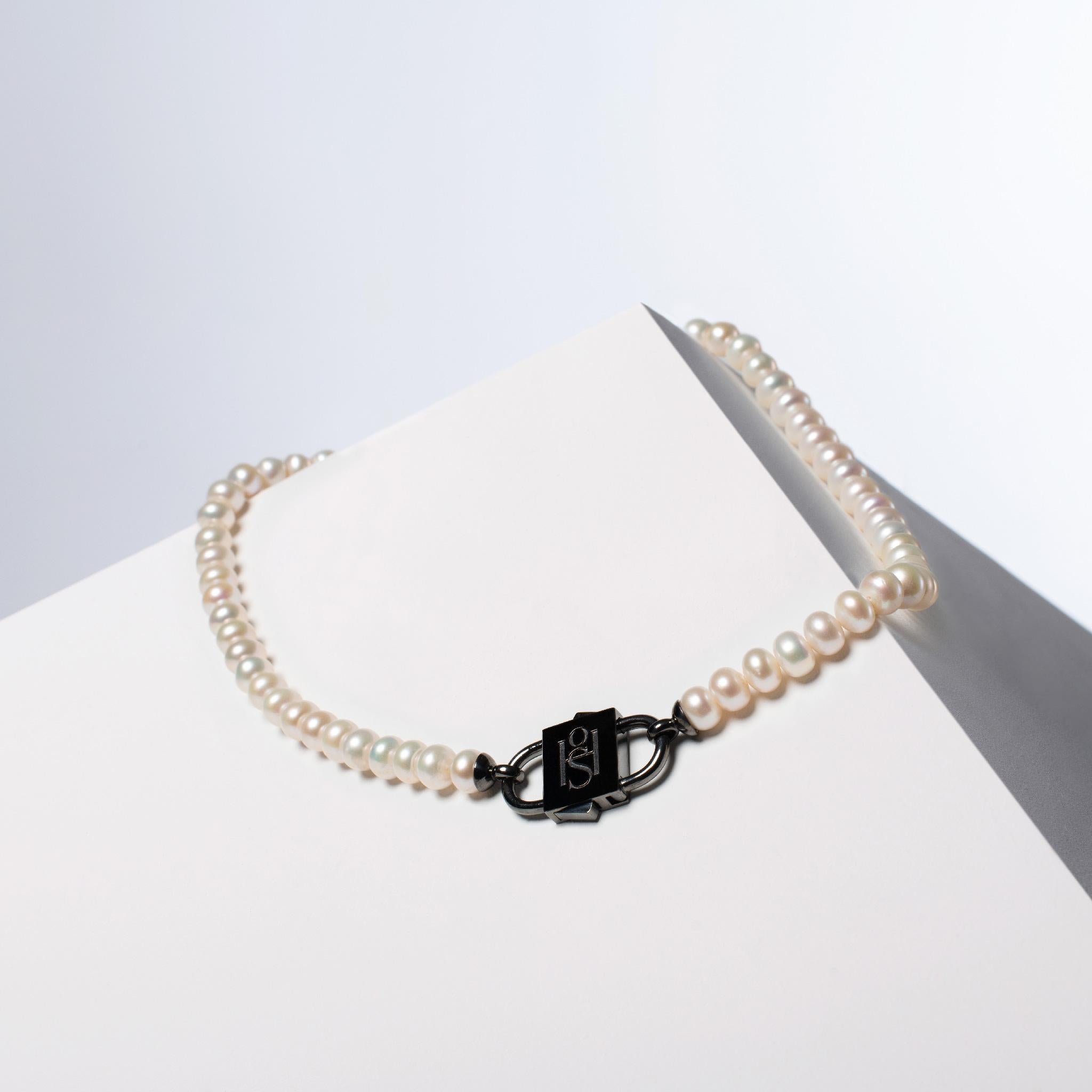 - Natural, high-luster white button pearl necklace with 1 micron Black rhodium filled 925 sterling silver HoS Lock™
- The Pearl Necklace measures 42.5 cm (16.7 inches) in length, offering an ideal size that gracefully adorns the neckline.
-