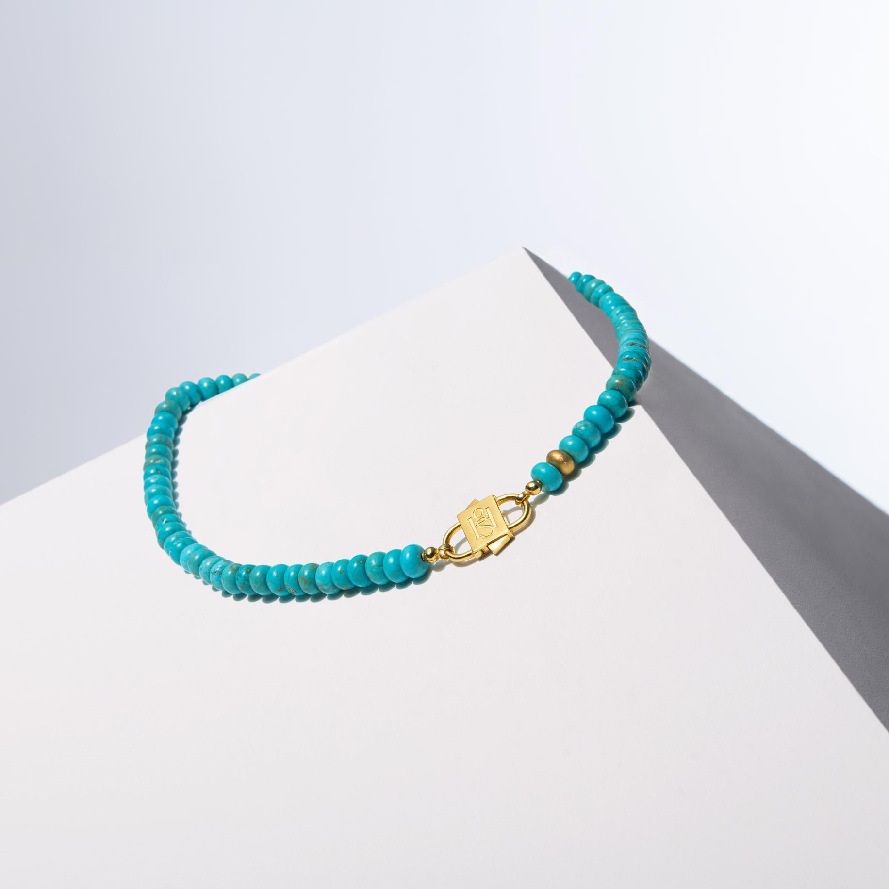 - Crafted with 8mm turquoise howlite rondelle beads, each bead adding to the uniqueness of the design with its natural texture and color variations.
- The design is elevated with a sandblasted, gold-filled silver bead, introducing an added layer of