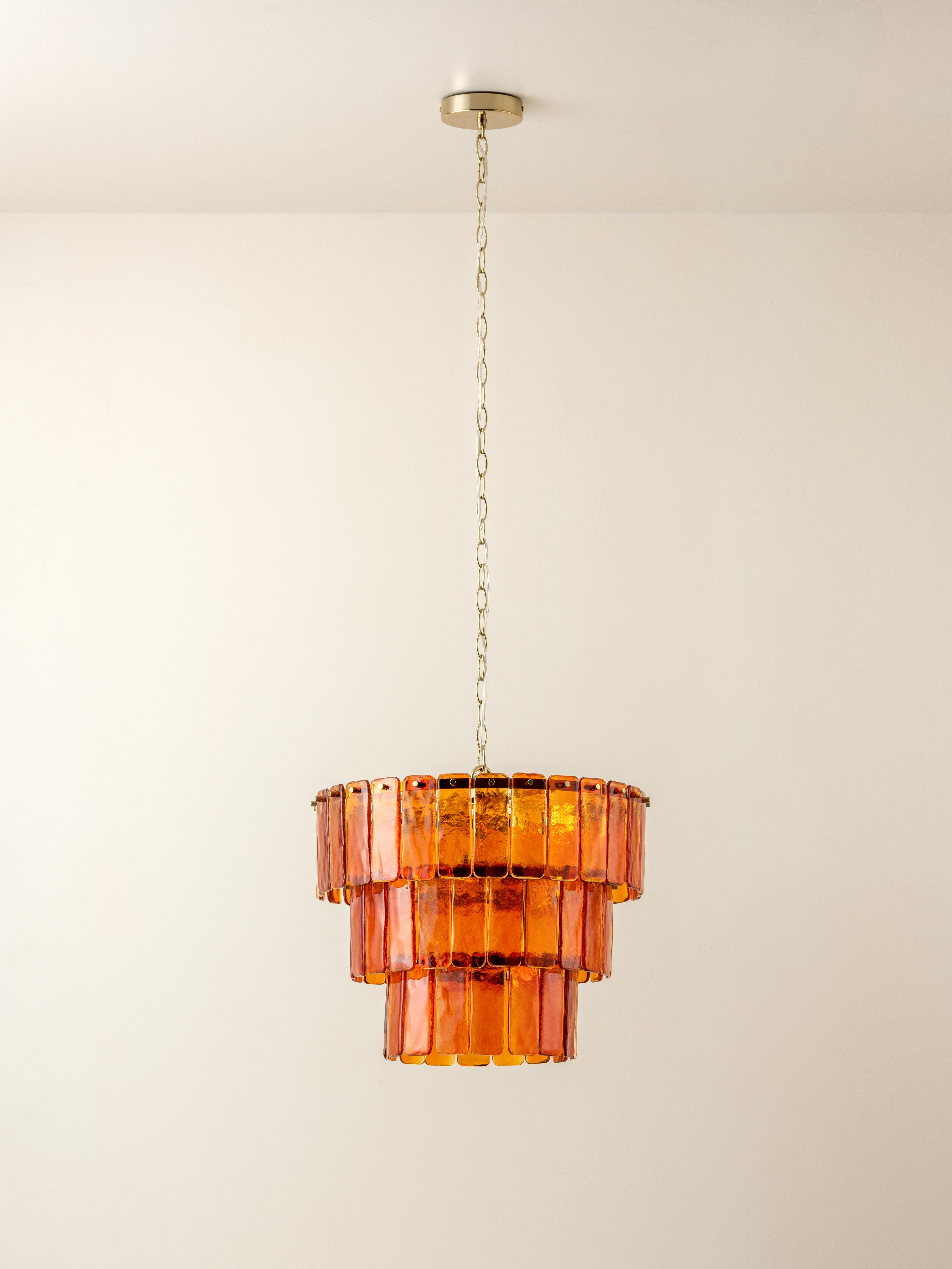 Enhance your home with our white glass disk ceiling light, a houseof masterpiece. This fixture has an adjustable brass frame, which suspends an array of frosted glass shades. Designed to make your home feel homely, these delicate shades refract and