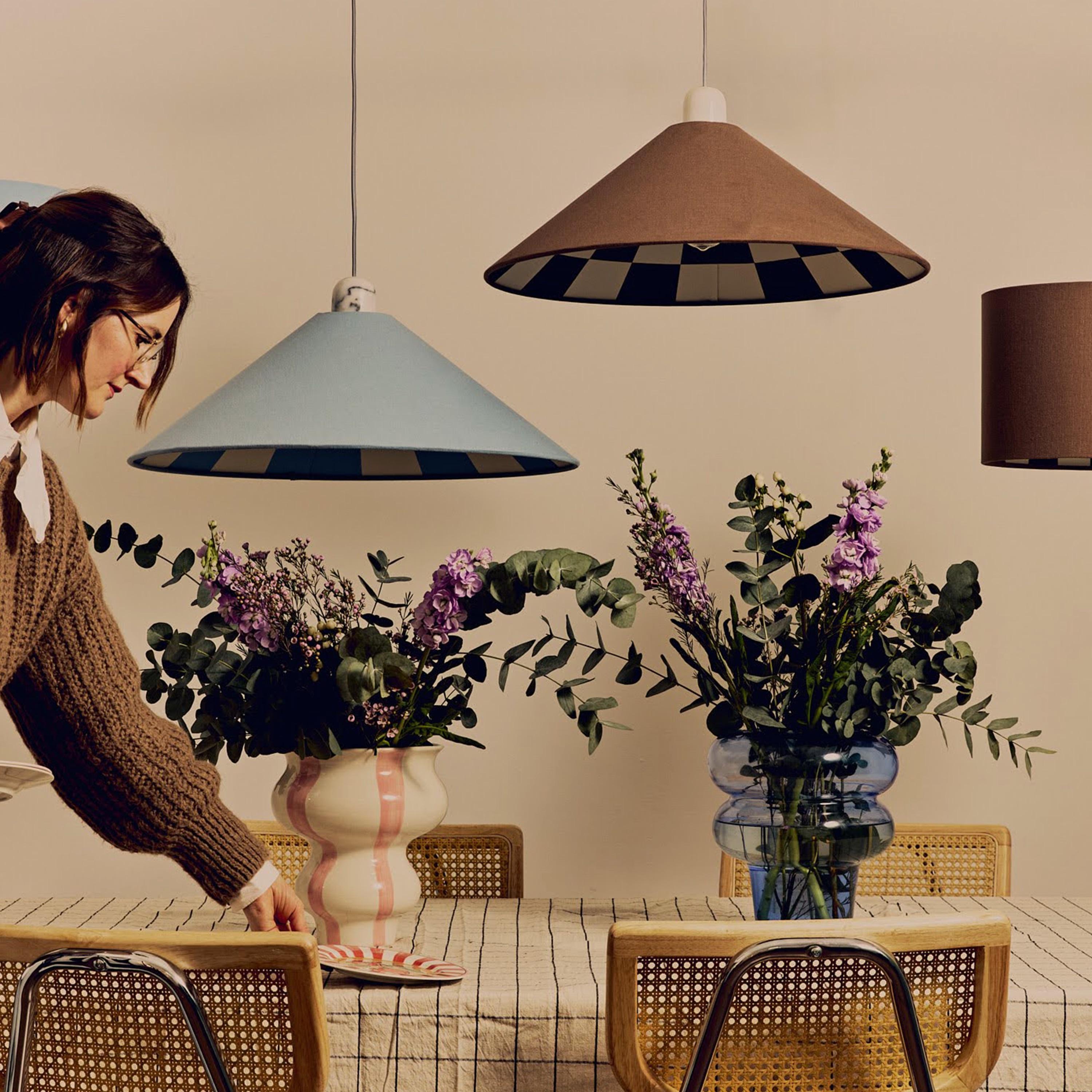 Our Bark brown checkered cone canvas shade is a bold and beautifully made lighting statement. Featuring a rich brown outer and a marshmallow-toned checkerboard inner lining, it blends timeless tone with on-trend detailing.

Handcrafted by