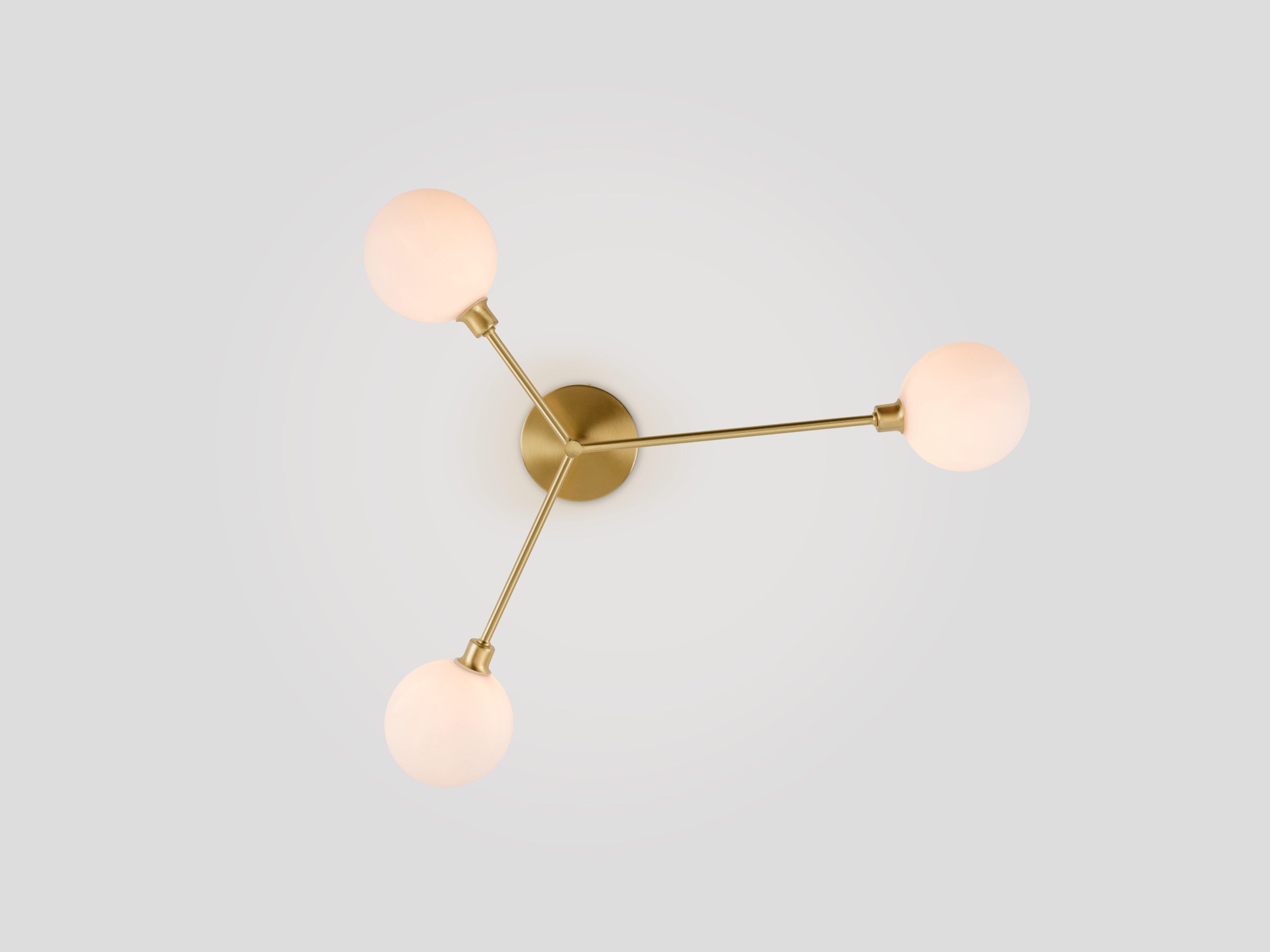 Upgrade your home with our bestselling 3 light flush ceiling light, the stylish centrepiece you need to make a statement. Three metal stems of varying lengths each suspend a large opal glass shade, which diffuses a warm, illuminating glow over your