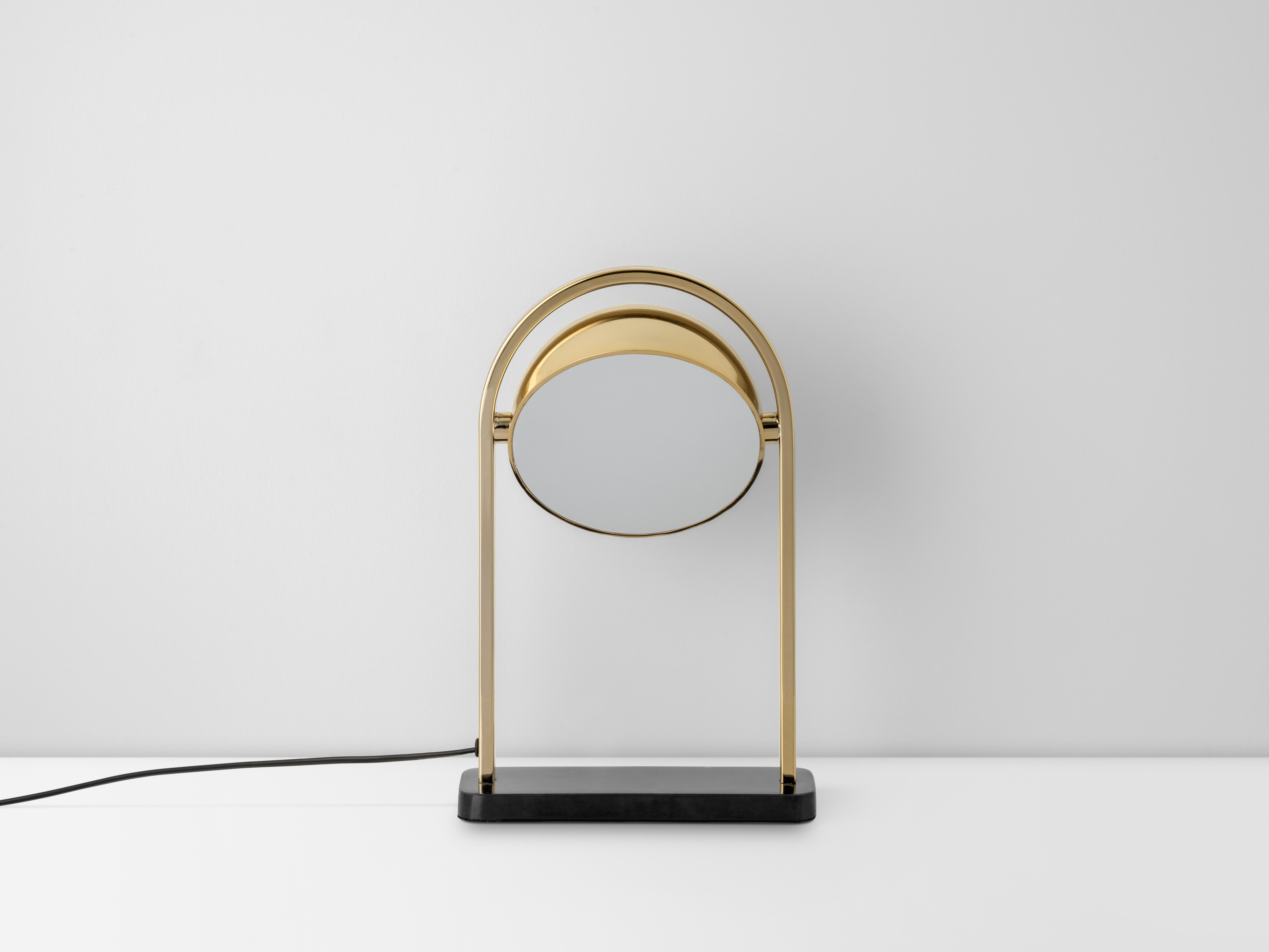 The striking brass LED dome table lamp features an arched metal frame that supports a dome shade that can be angled to your preferred direction of light. Finished off with a sleek and stylish black marble base, this striking investment table lamp is