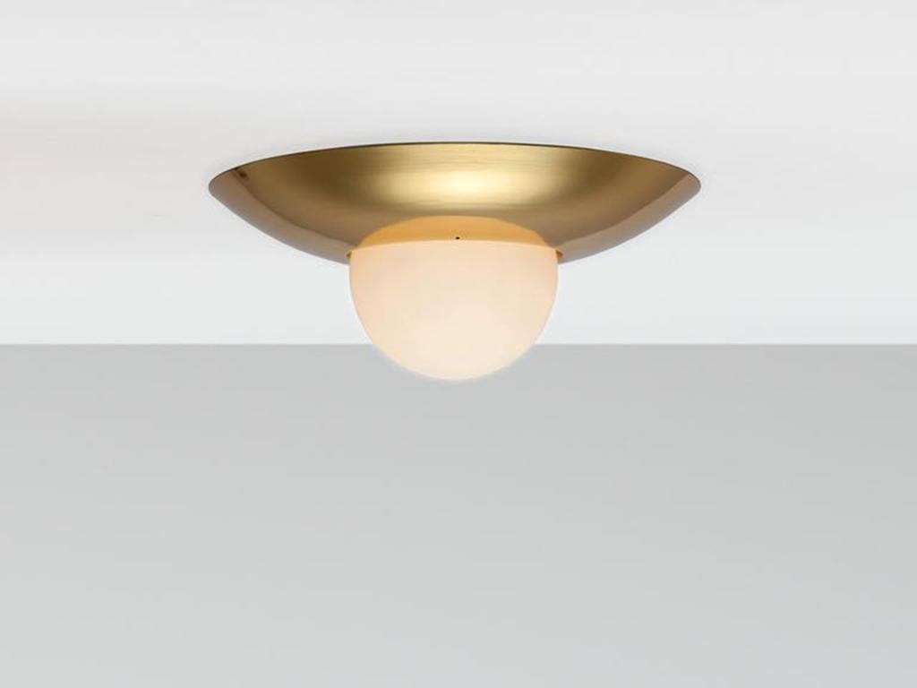 This low profile flush fit ceiling light is bathroom and perfect for low ceilings. The dome metal frame encloses an opal glass shade, which diffuse a warm illuminating glow. Ideal for a kitchen or bathroom. IP44 bathroom rated. Flush-fit. Rich and