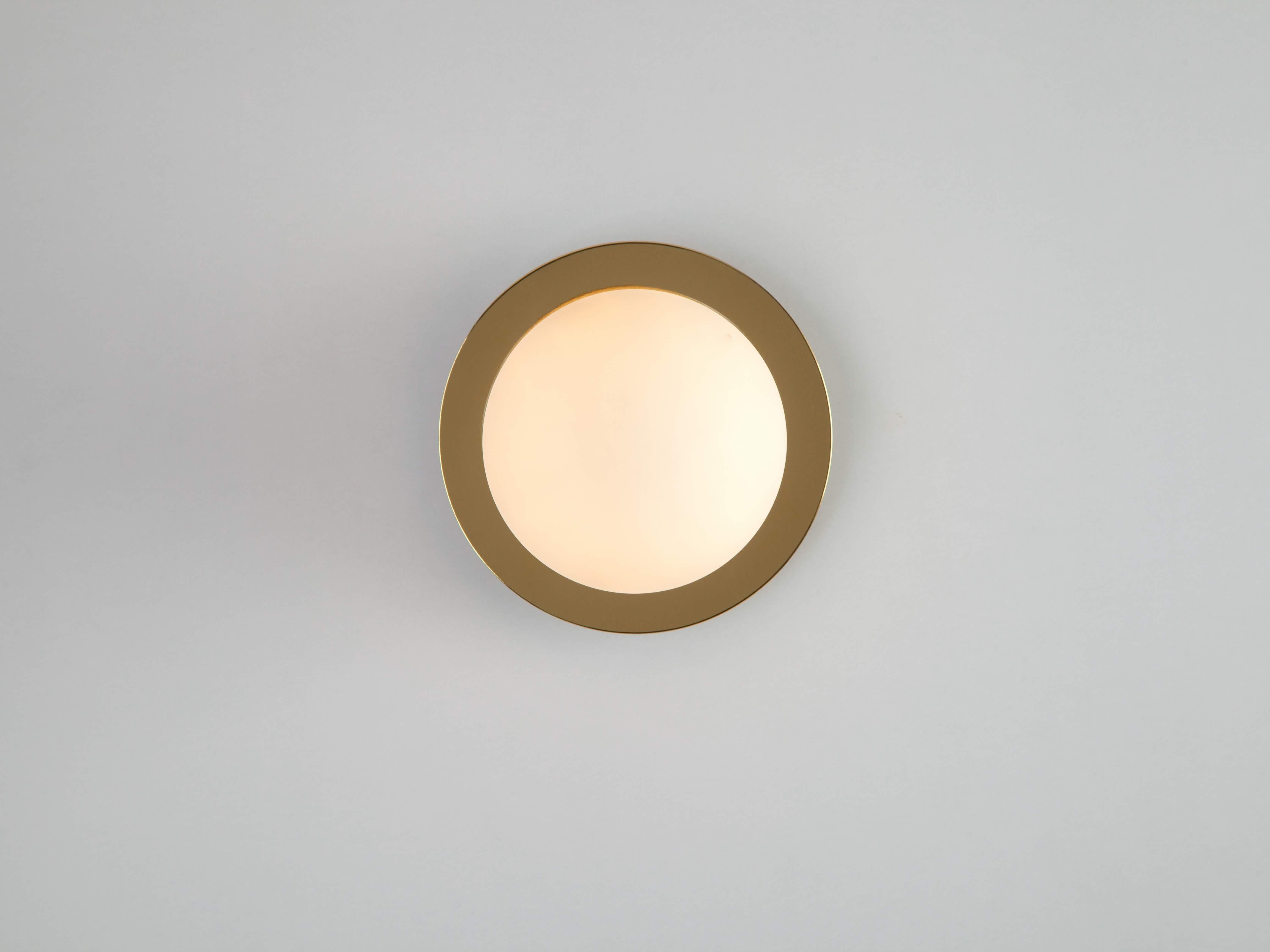 This modern wall light works everywhere. The disk mounted, opal glass shade, diffuses a warm illuminating glow. Ideal for a living space, kitchen, bedroom or bathroom. Our Brass is the houseof staple that accentuates and emphasises. The polished