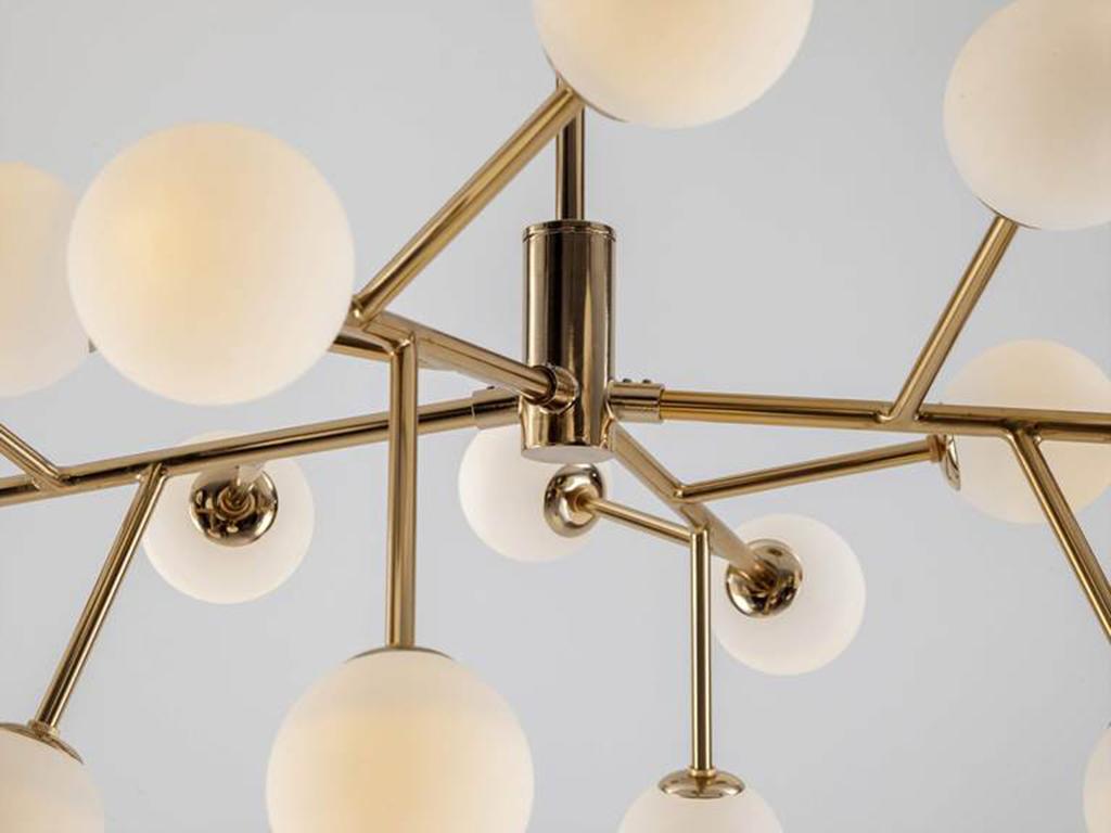 This flush fit, statement ceiling light is a houseof icon. The multi-arm metal frame, suspends 15 integrated LED opal glass shades, which diffuse a warm illuminating glow. Ideal for a bedroom, hall or living space. Rich and opulent, Brass is the