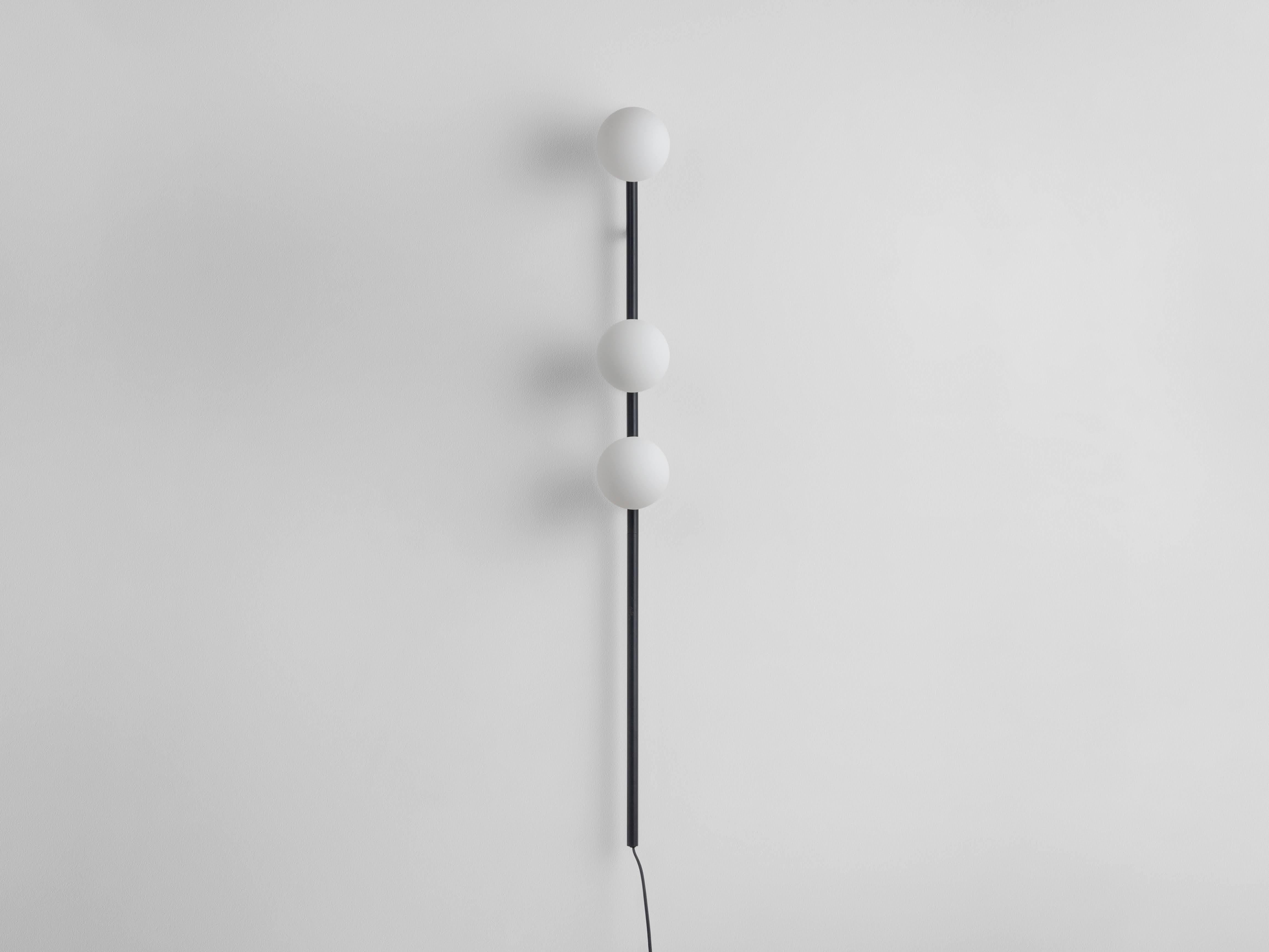 A perfect space saving light our bold charcoal grey bar opal ball wall light. With the power of a floor lamp but without the footprint, the metal bar holds three opal glass shades, which diffuse a soft, illuminating glow over your living spaces;