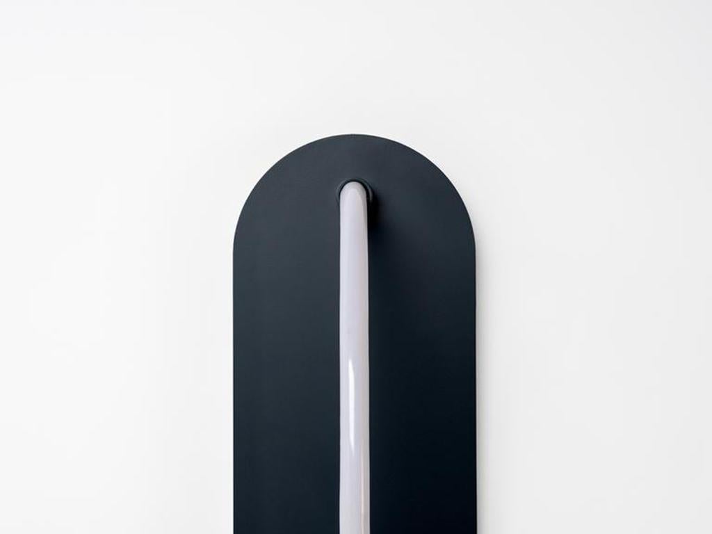 This oversized LED wall light works with both retro and modern interiors. The solid metal backplate frames a curved LED strip light, that emits a warm illuminating glow. Ideal for a bedside or living space. Or pitch nearly black, Charcoal grey is