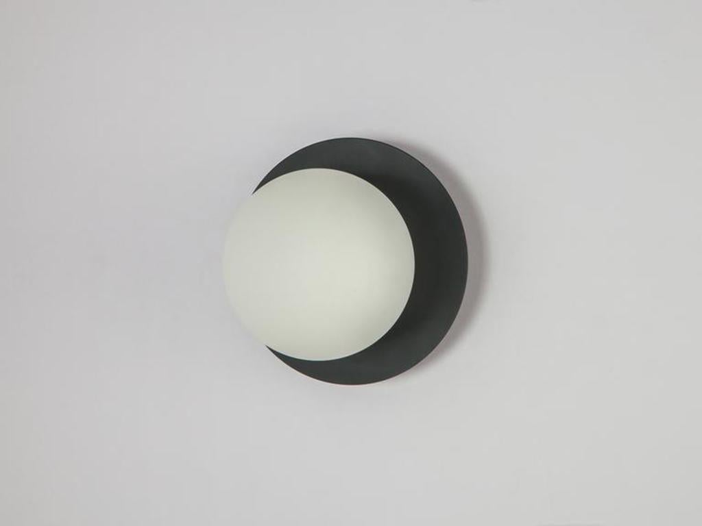 This modern wall light works everywhere. The disk mounted, opal glass shade, diffuses a warm illuminating glow. Ideal for a living space, kitchen, bedroom or bathroom. Or pitch nearly black, Charcoal grey is the houseof staple that accentuates and