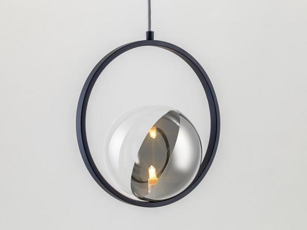 This unique modern ceiling light is designed to style in multiples. The adjustable metal ring ecases a large half plated glass globe, which diffuses a warm illuminating glow. Ideal for over a breakfast bar or dining table. Or pitch nearly black,