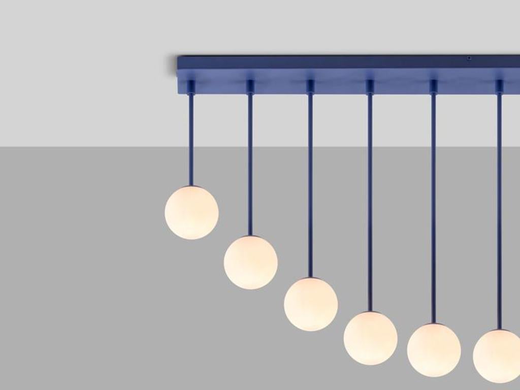 This striking flush fit ceiling light looks incredible when styled in multiples. Ten fixed metal arms, suspending an opal glass shades, form an inverted arch, which diffuses a warm illuminating glow. Ideal for a dining space or a breakfast bar. This