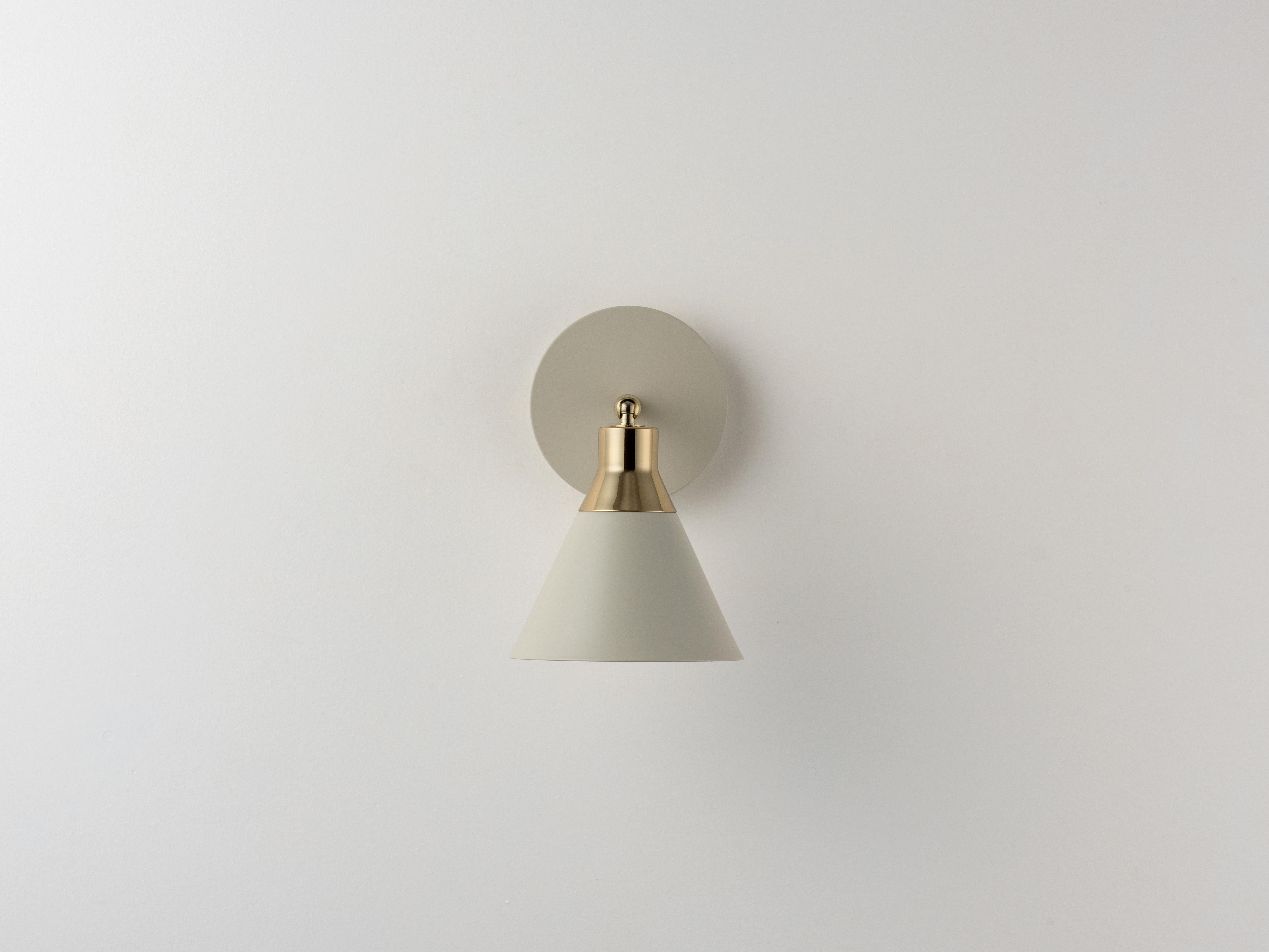 Designed with versatility and function in mind, the conical shade is perfect for spaces where direct light is needed. This cone wall light, petite in size, has an adjustable shade which makes it perfect for bedside reading, desk work and kitchen