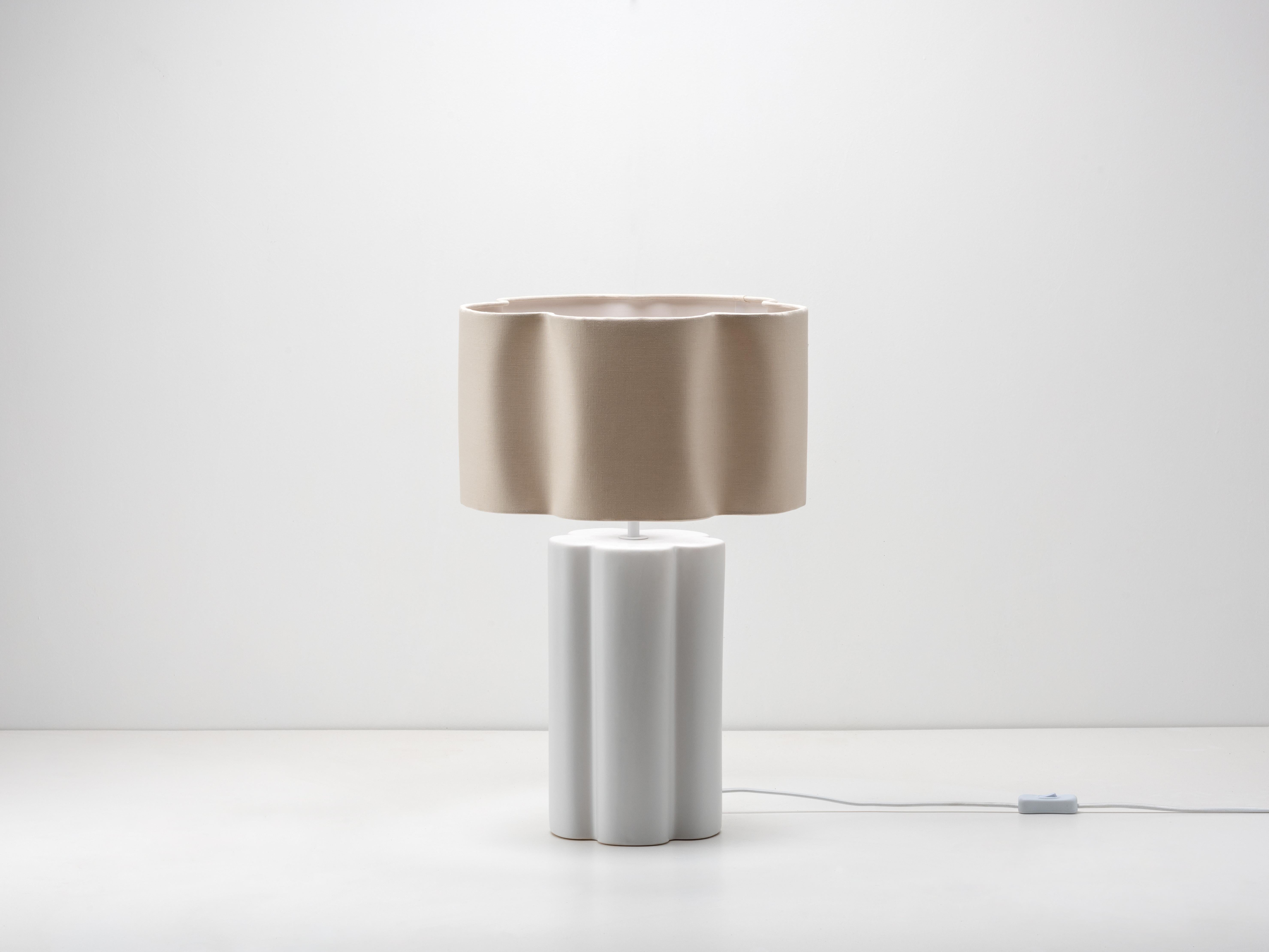 Soften your interior with the natural elements of ceramic and linen. The sculptural ceramic base complements the flower-shaped linen shade. Standing tall at 54cm, this table lamp will make a statement on a sideboard or create warmth in a hallway or
