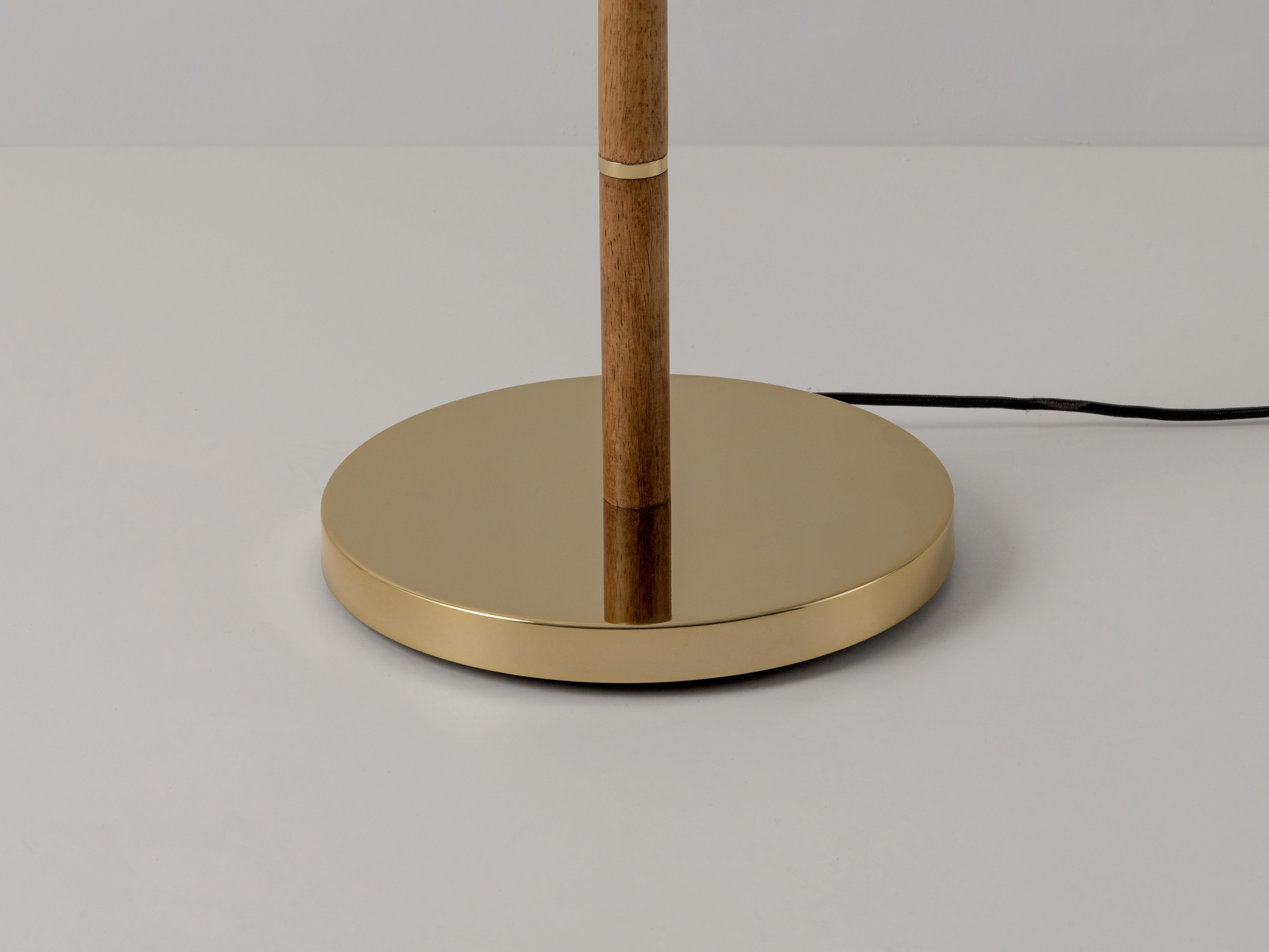Please note this item is on pre-order. 

This floor lamp exudes a sense of calm and luxury, with considered details such as a pull switch and responsibly sourced wood. The contrasting textures of slubby linen, smooth brass and walnut-toned wood work