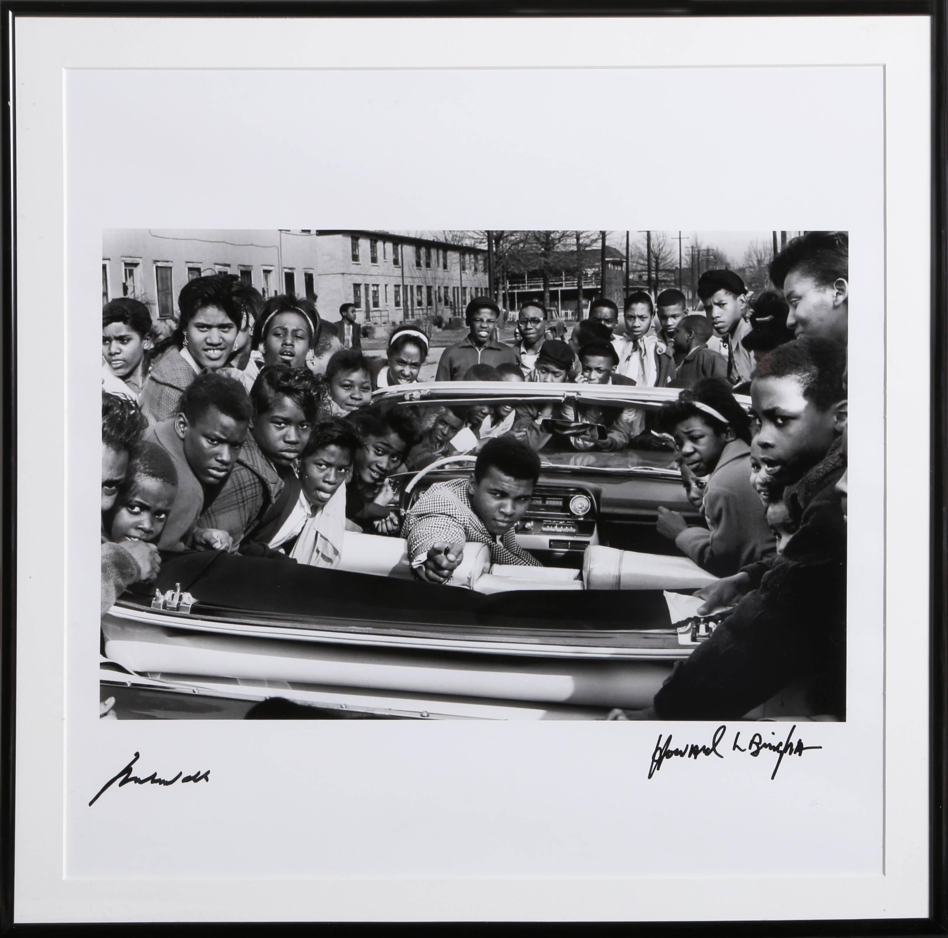 Artist: Howard Bingham, American (b. 1939)
Title: Cassius Clay in Louisville, Pink Cadillac
Medium: Gelatin Silver Print Photograph, signed by Bingham and autographed by Ali in marker
Year: 1963 (printed 2003)
Image Size: 15.5 x 10.5 inches
Size: 20