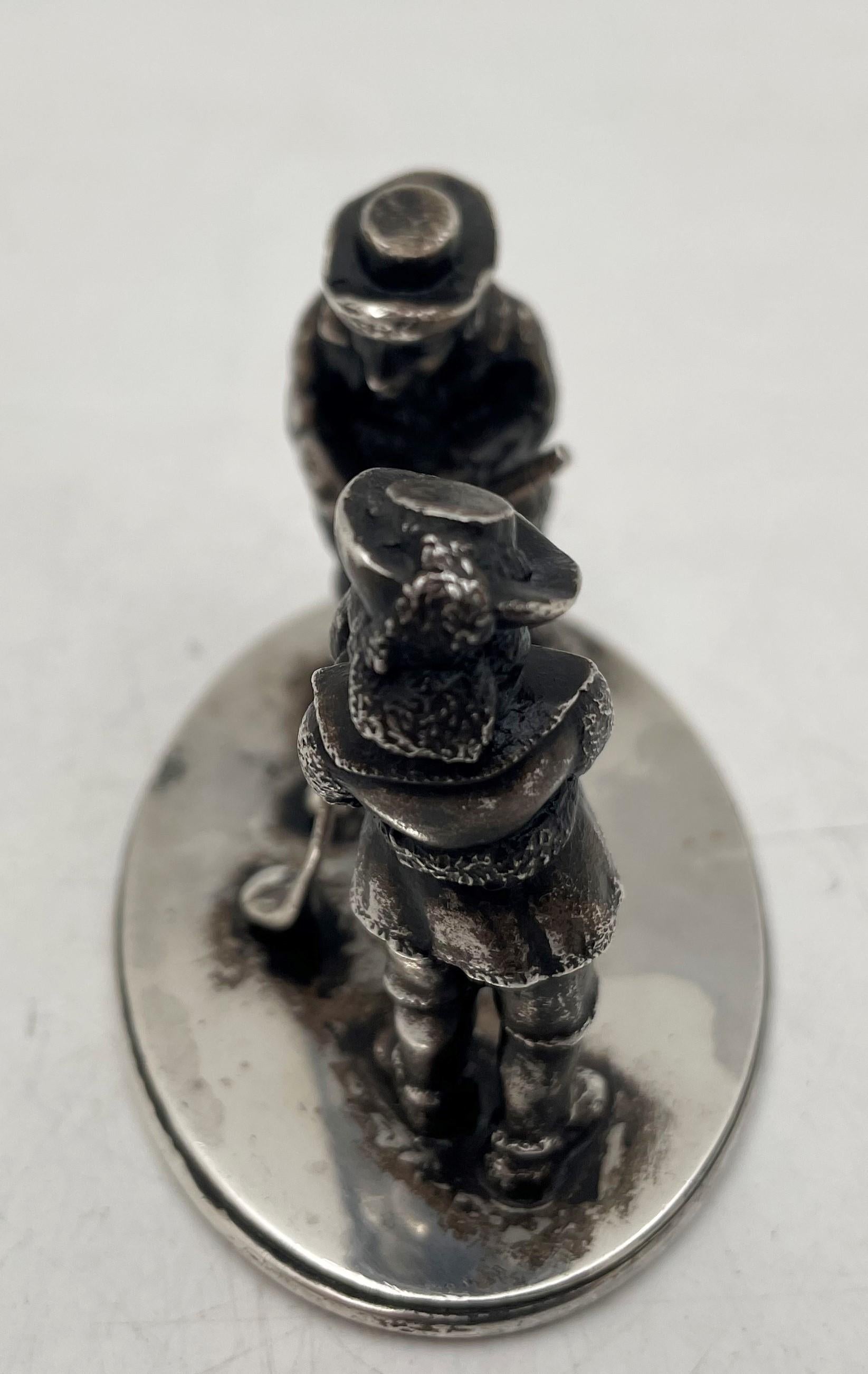 Howard & Co., sterling silver, late 19th or early 20th century, highly detailed and realistic miniature of 2 golfers on a stand. It measures 2 1/4'' in height by 3 1/8'' in width by 2'' in depth, and bears hallmarks as shown. 

Howard & Company was
