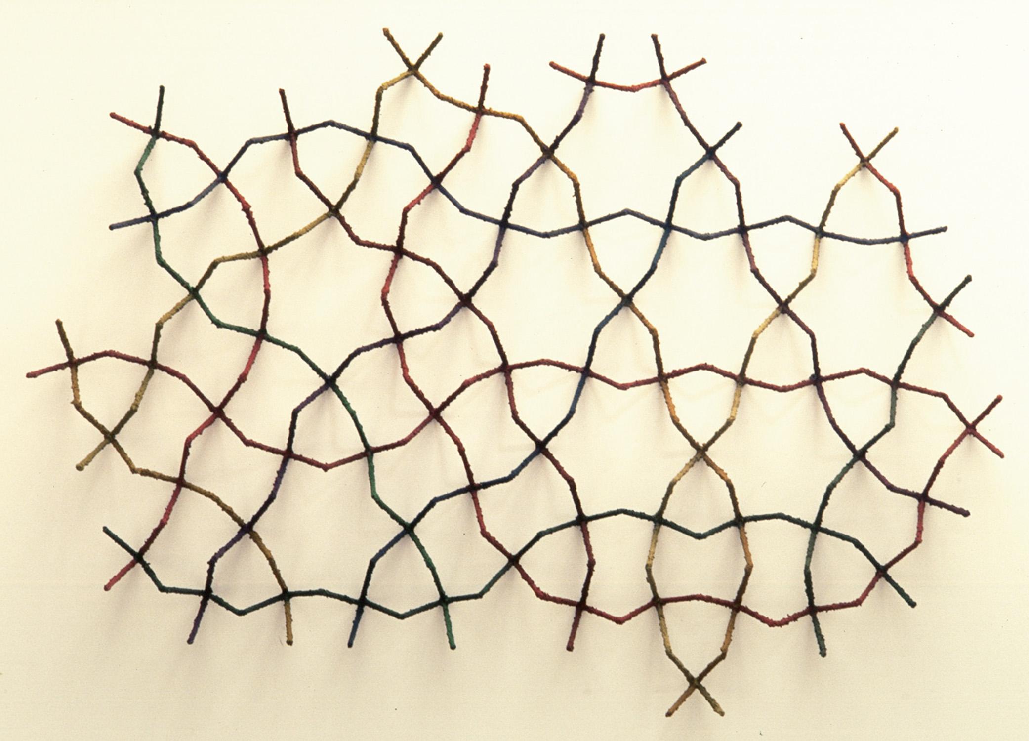 Howard Kalish Abstract Sculpture - CRWall screen of colorful lines creates an intricate play of shadows on the wall