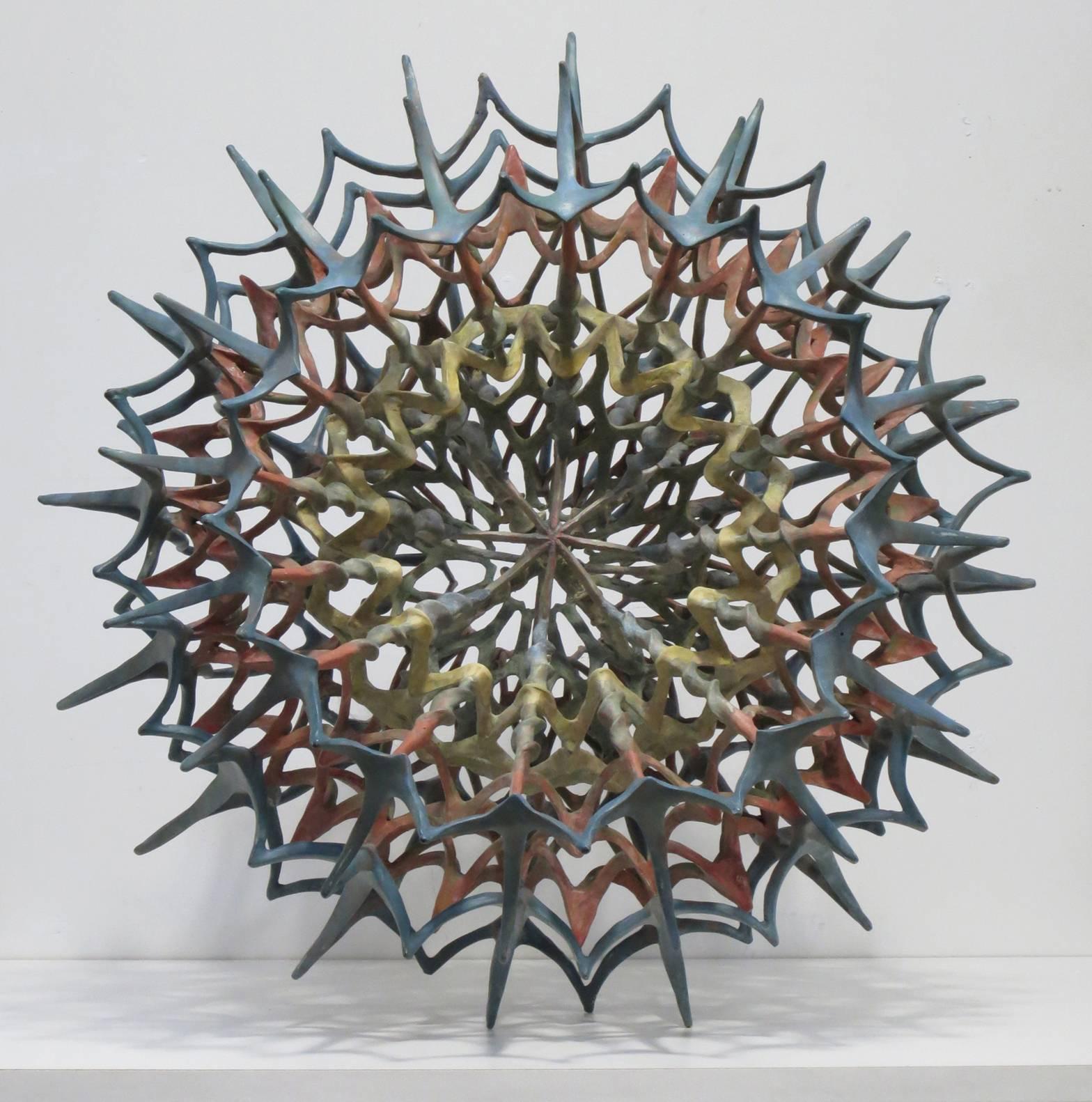 "Inside 1", open sphere of intricate linked forms in muted red, blue and yellow - Sculpture by Howard Kalish