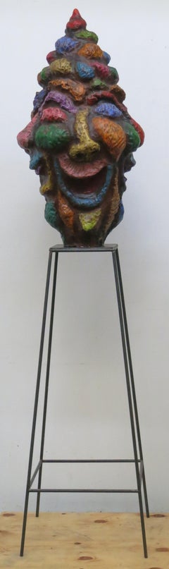 "Large Head (Trickster)" with four laughing faces in orange, green, blue, pink