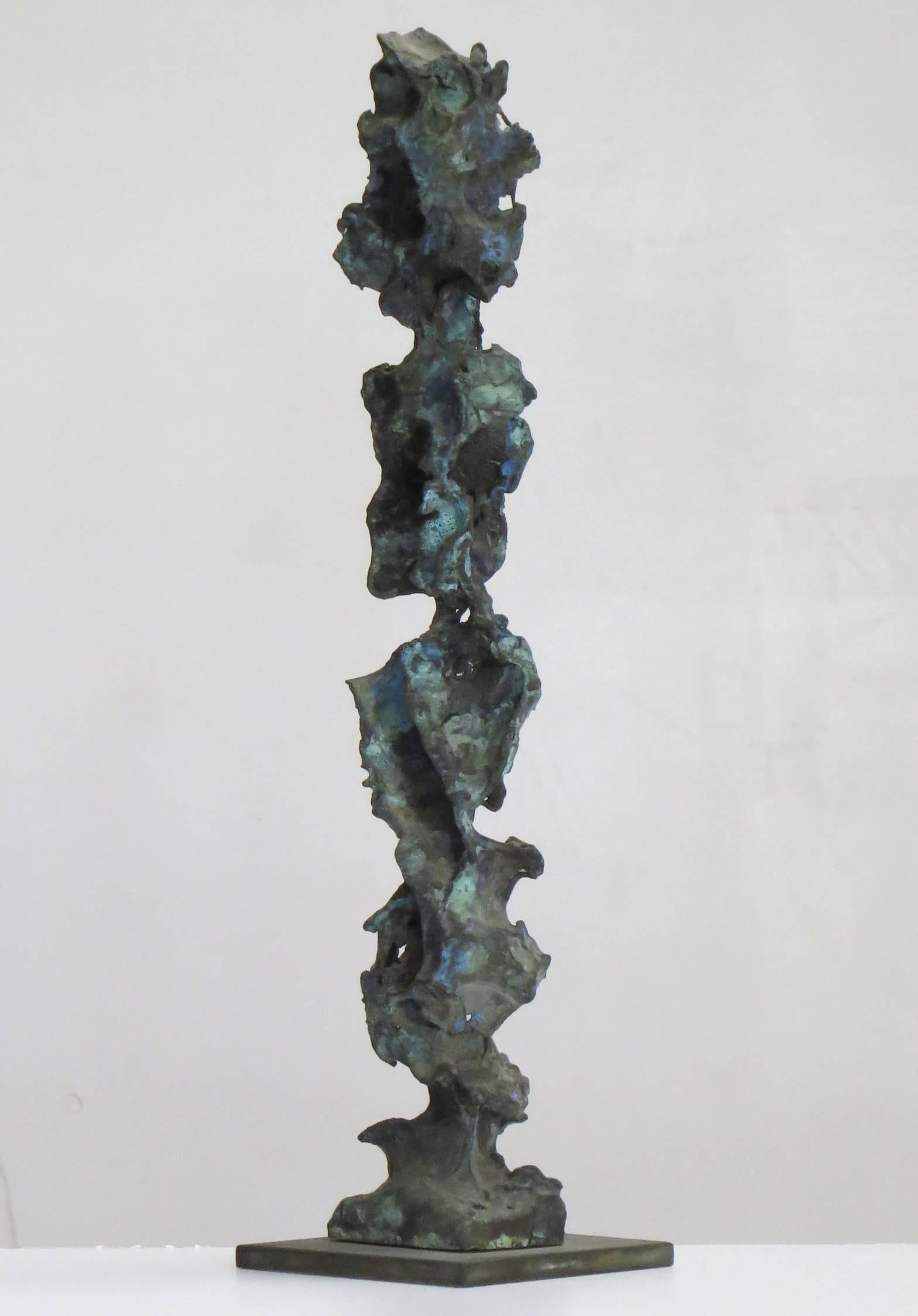 Stoic, intricately carved, textured tabletop bronze with a blue green patina, is varied from every viewpoint. To Kalish, the most important factor in determining what a sculpture will become is the structural principle. The juxtaposition of forms