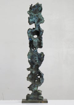 "Stoic", intricately carved, textured tabletop bronze with a blue green patina  