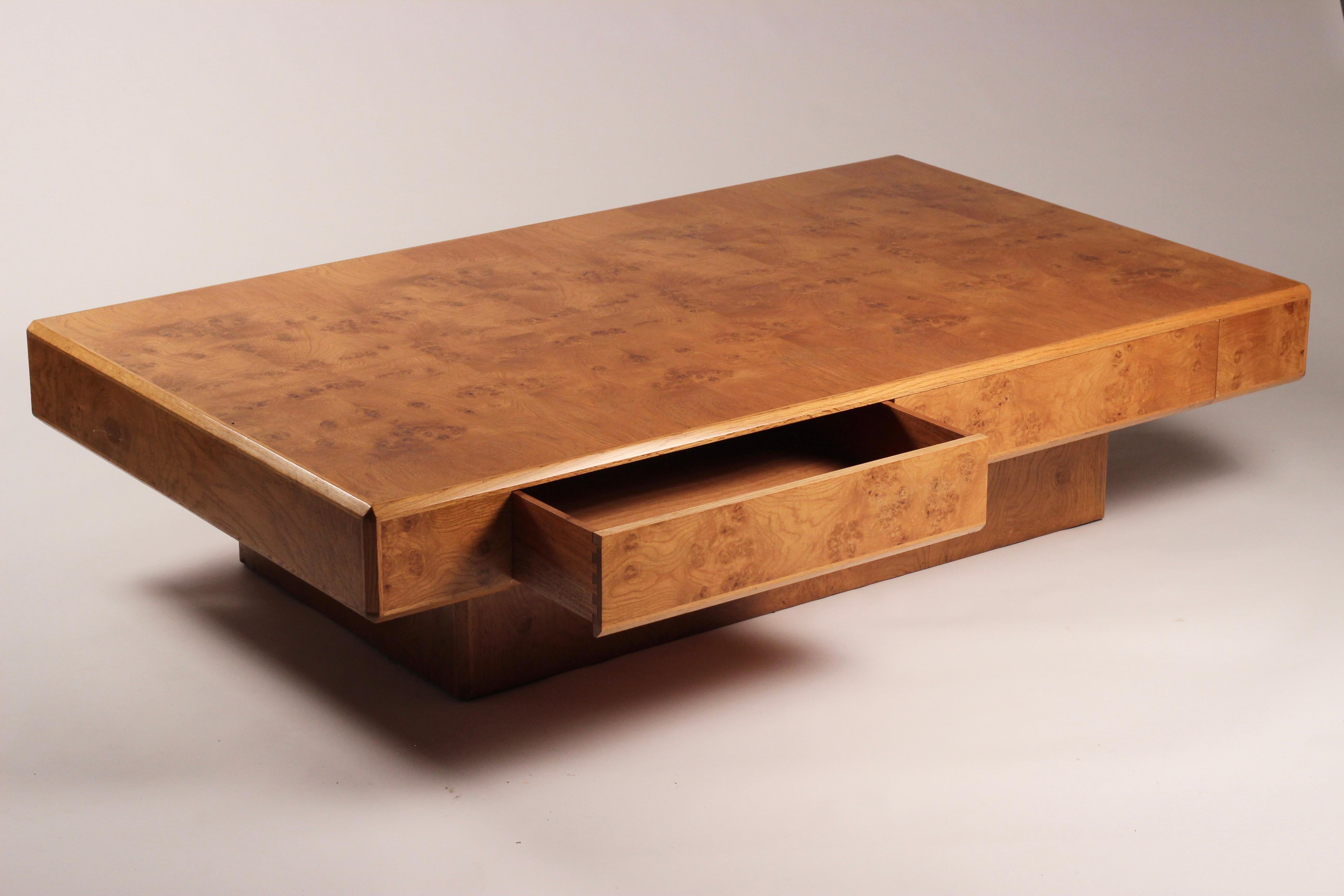 A beautifully proportioned Burl walnut coffee table by Howard Keith for MK with concealed drawers, also faced in book match Burl Veneer. The book matching of veneers has been skilfully put together to produce a mesmerising pattern, that has then