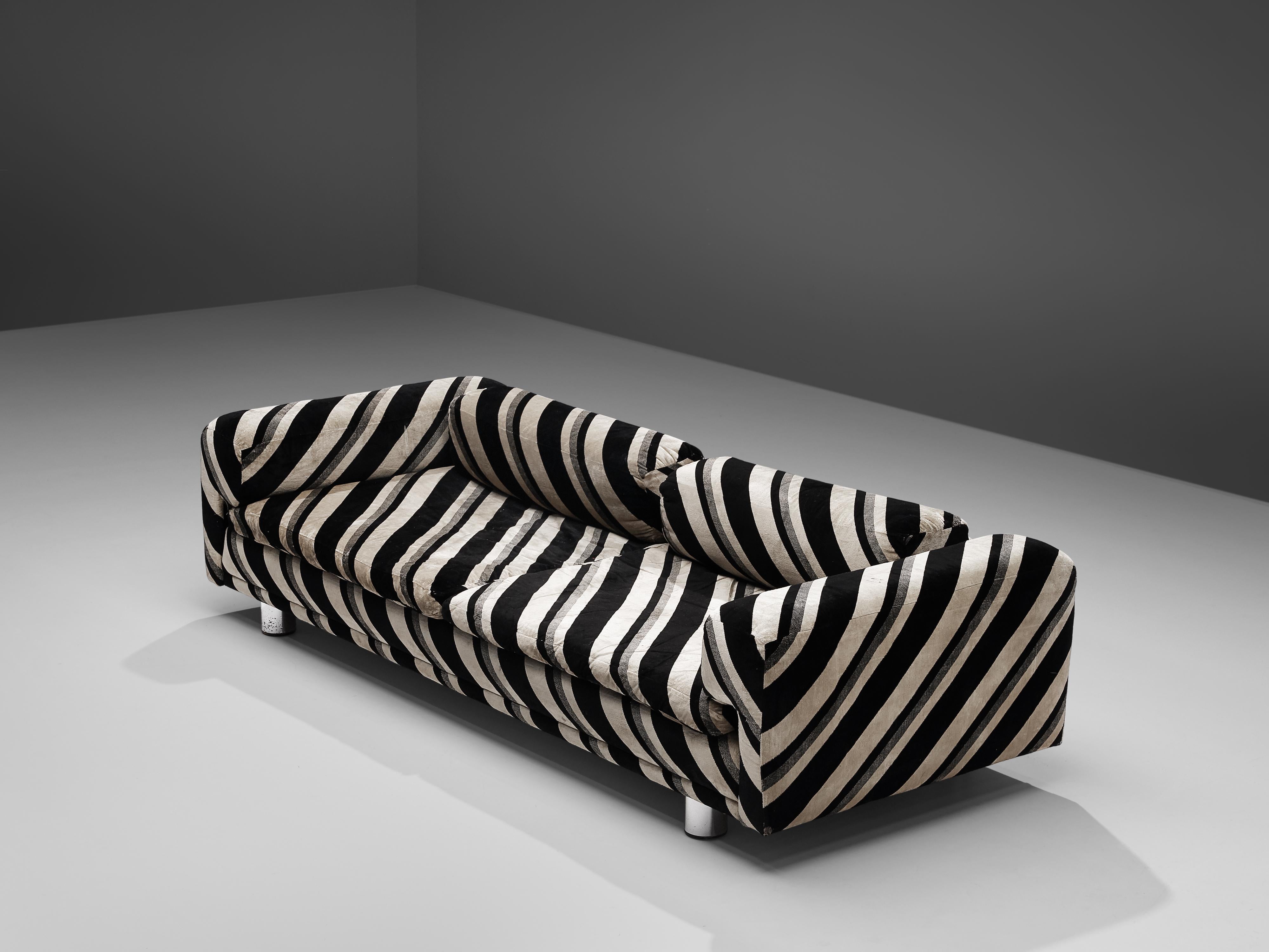 Howard Keith for HK Furniture, 'Diplomat' sofa, black and beige striped fabric, metal, United Kingdom, 1970s.

Grand voluptuous 'Diplomat' sofas by Howard Keith for HK Furniture, designed in the 1970s. This sofa with a deep seat is a true delight
