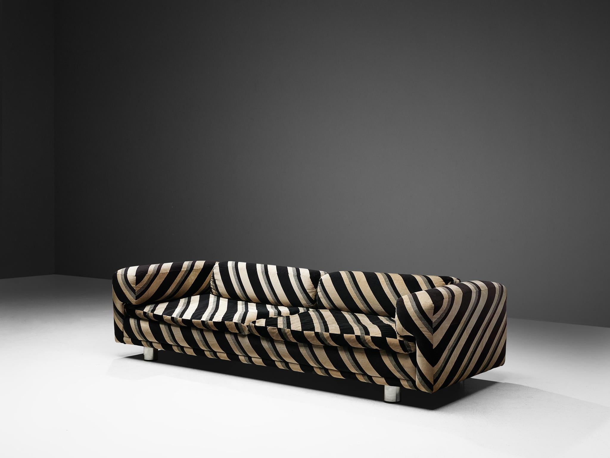 Howard Keith, 'Diplomat' sofa, dark brown and beige striped fabric, metal, United Kingdom, 1970s.

Grand voluptuous sofa by Howard Keith for HK Furniture, designed in the 1970s. This sofa with a deep seat is a true delight to sit and relax in. The