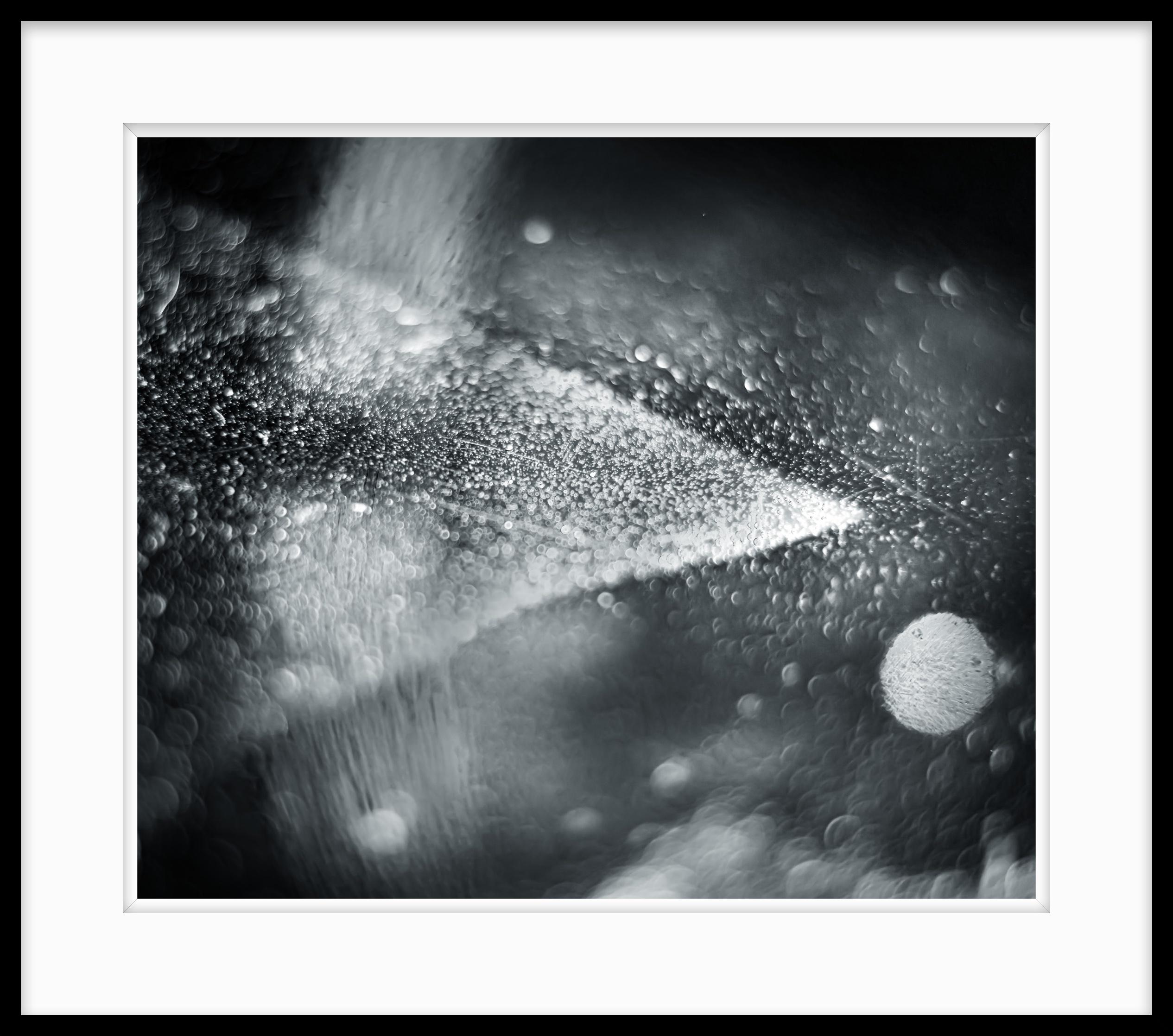This is Untitled #47 from the Nature of Particles series.

The Nature of Particles series consists of abstract photographs of ordinary particulates, that we observe in our everyday surroundings as floating fragments seen in shafts of light.

My