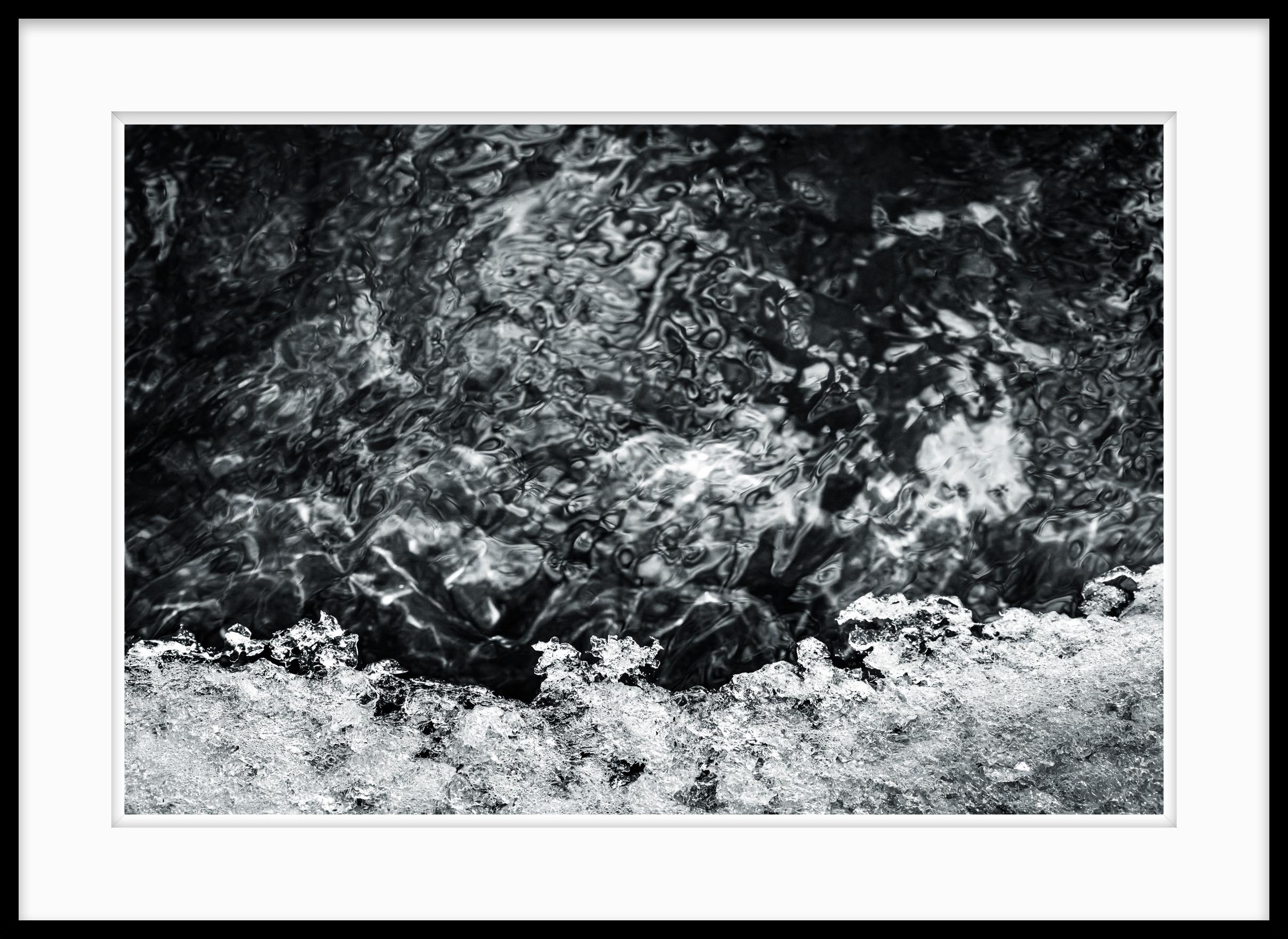 This is a limited edition black and white photograph called Spring Thaw taken in 2021.  I like to photograph around the rivers in the spring. Spring Thaw is emblematic of the myriad of abstractions of water and melting ice that happen when the