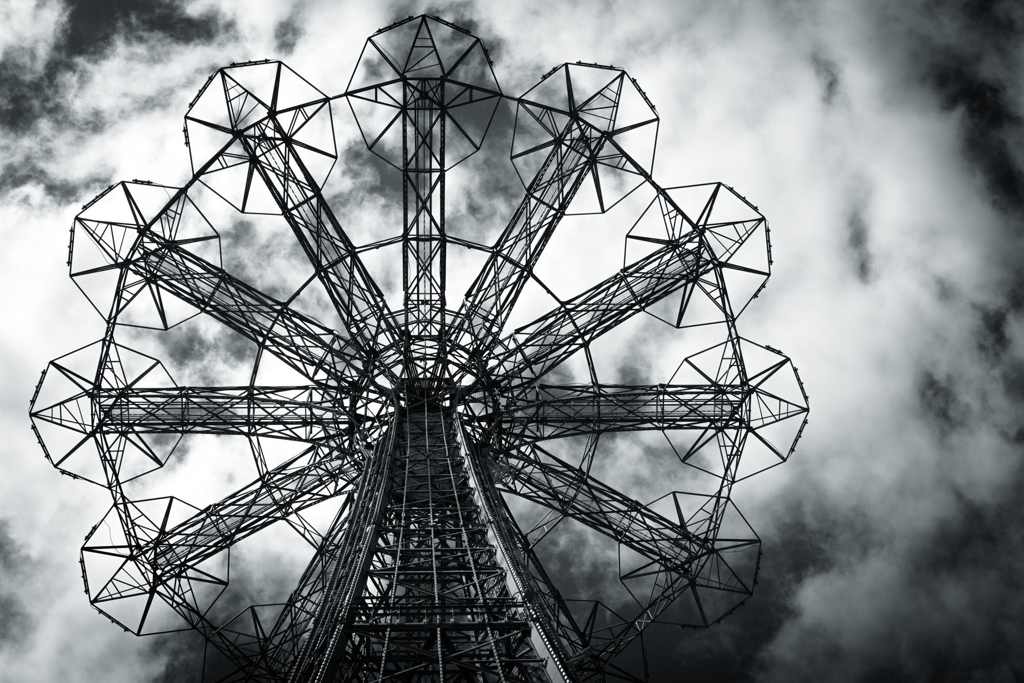 Beautiful, detailed limited edition black and white toned archival pigment print. This photograph was taken of the old deserted parachute drop at Coney Island amusement part in the early spring of 2021. Title - Coney Skeleton

About:
Lewis’ artistic