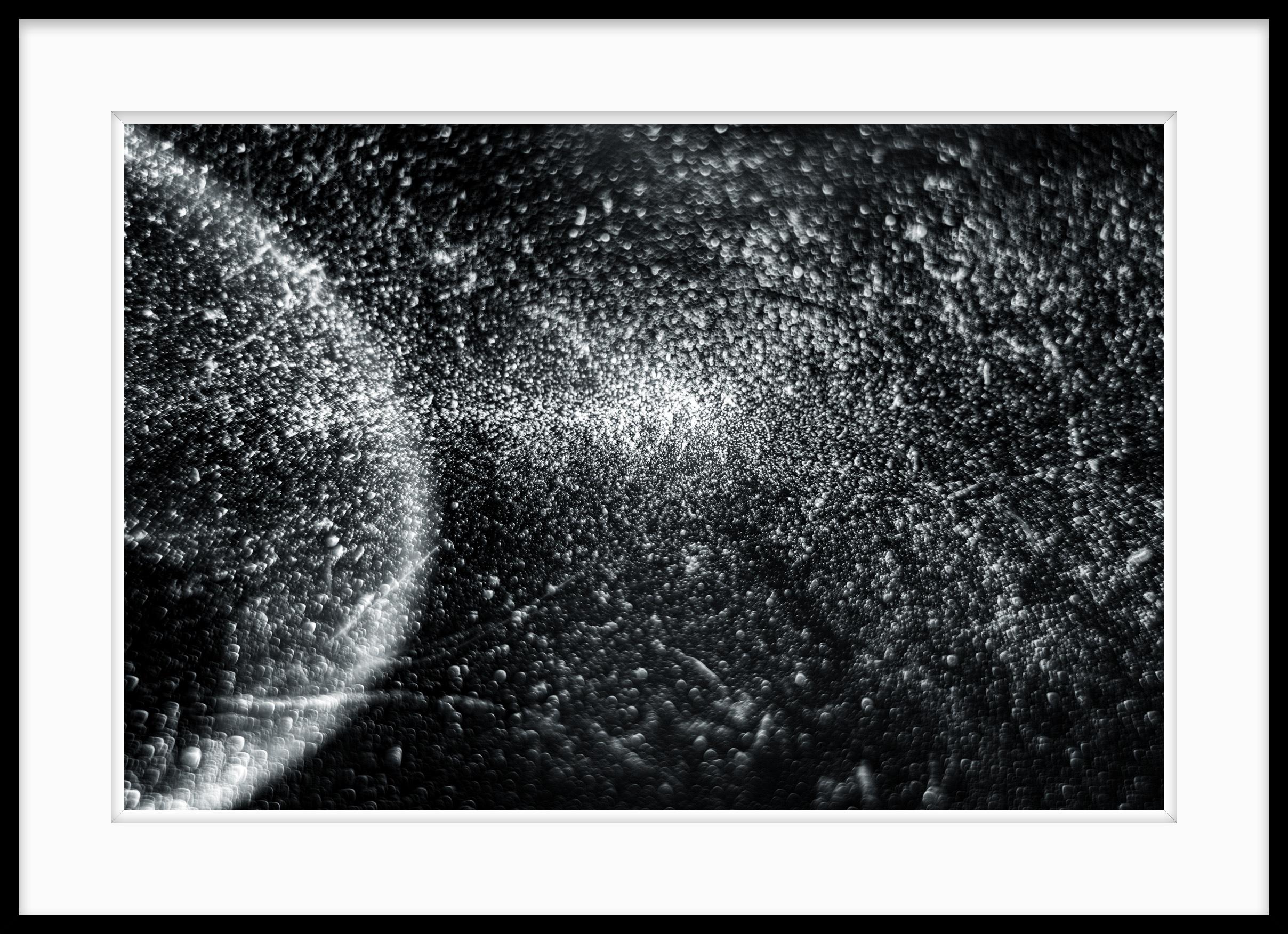 This is Untitled #44 from the Nature of Particles series.

The Nature of Particles series consists of abstract photographs of ordinary particulates, that we observe in our everyday surroundings as floating fragments seen in shafts of light.

My