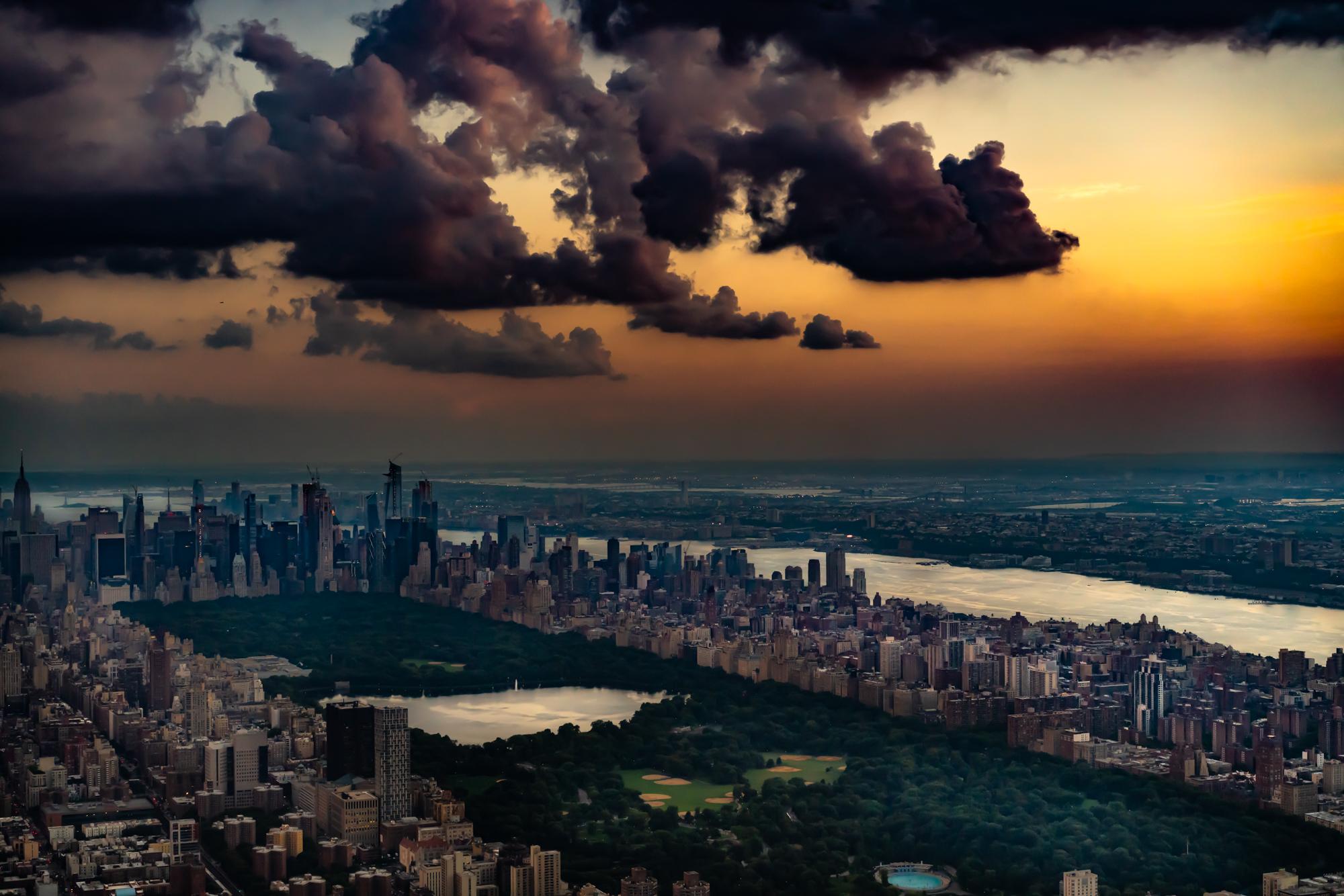 Limited Edition Color Photograph - New York aerial, Central Park, 2018. When the ban on taking the doors off of helicopters for photography was lifted I flew over New York City late in the day just after storms had passed. Central Park with the lake