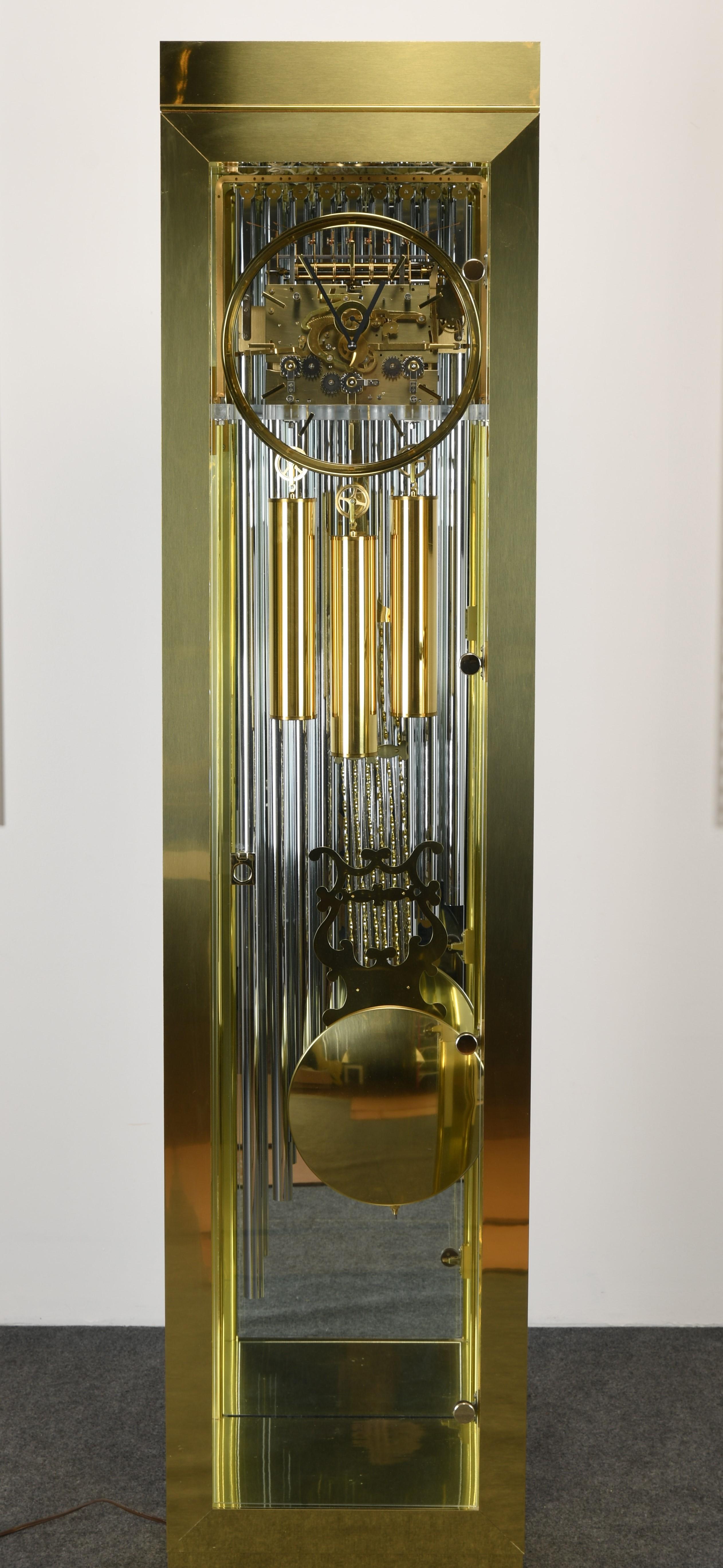 A fabulous Howard Miller Grandfather Clock with a brass skeleton frame. The clock is in very good condition with a few minor dings to the floor from weights. The chimes have a beautiful sound and the clock lights up as well, as shown in images. This