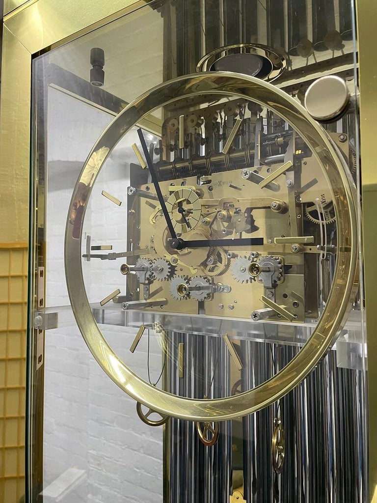 Howard Miller Grandfather clock with a brass and glass frame. The clock has weights, a beautiful pendulum, chimes and the clock lights up as well. 

 