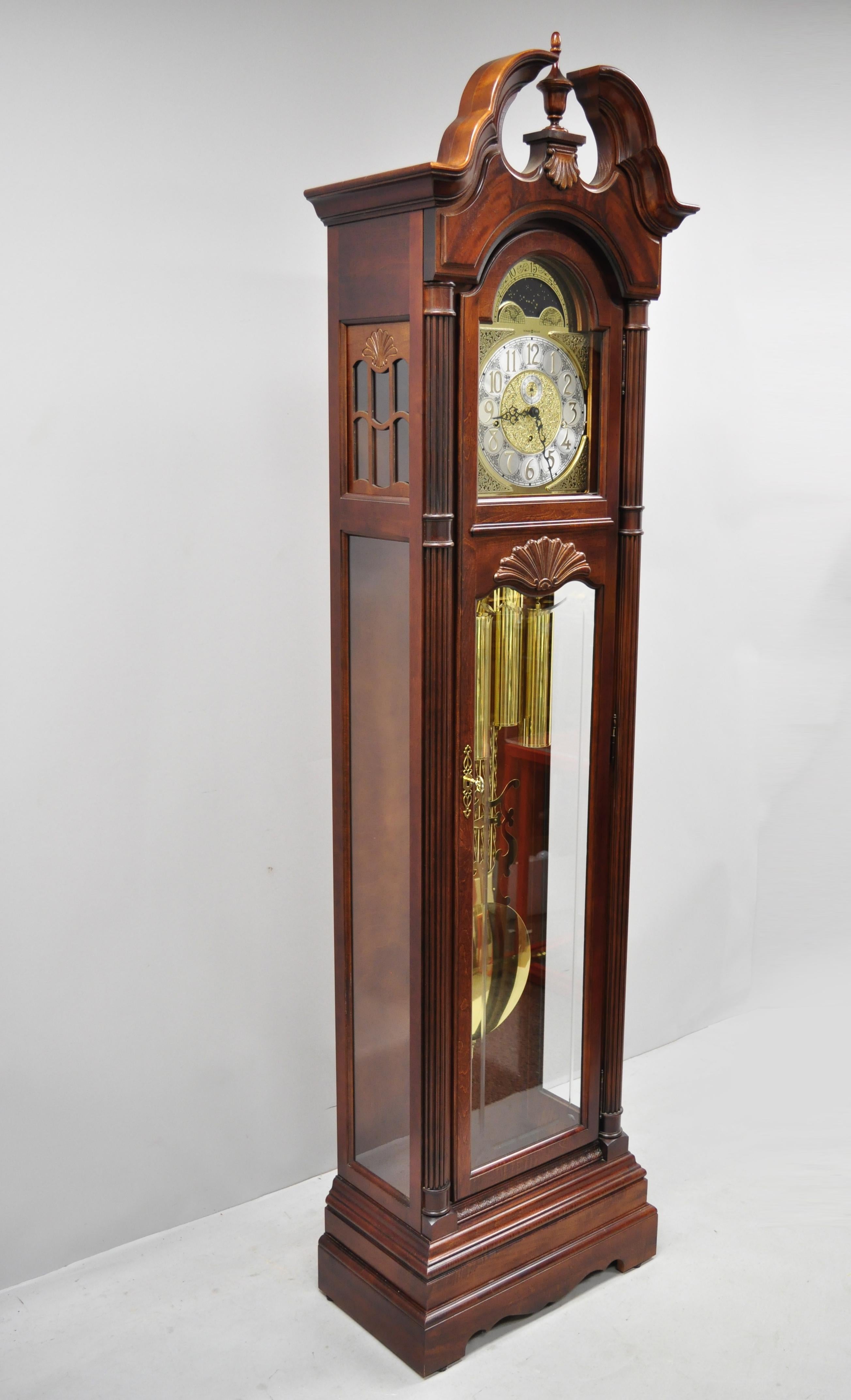 Howard Miller Landsbury Grandfather clock 610-698 cherry tall case. Item features Windsor cherry finish, astrological blue moon phase dial, cable-driven, triple chime, original label, working lock and key, quality American craftsmanship, original