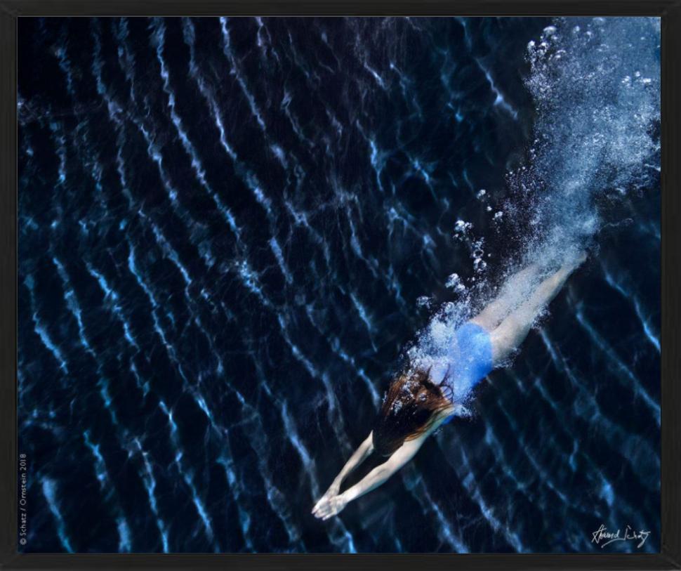 Underwater Study #3024 - model swimming in an ocean blue water - Photograph by Howard Schatz