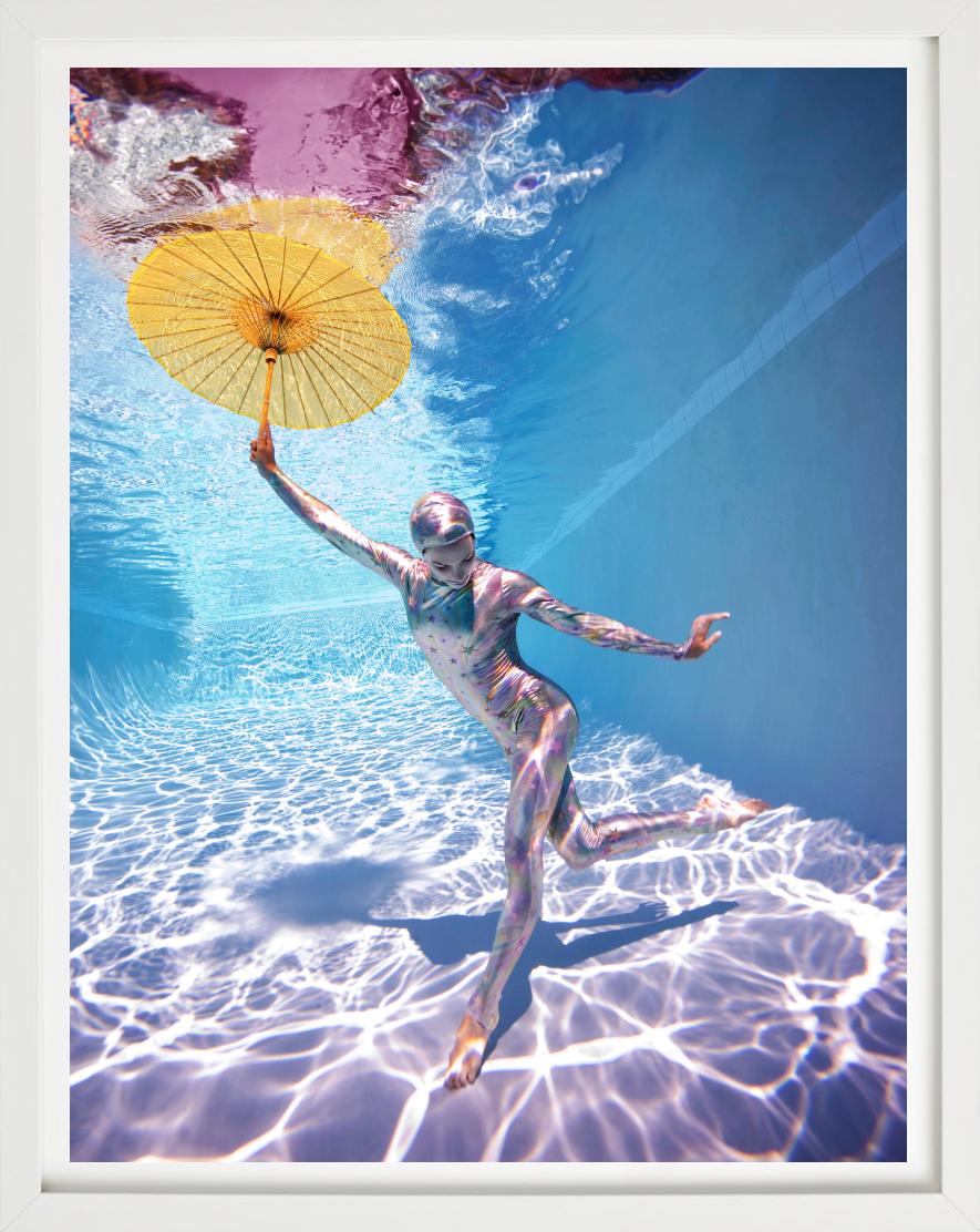 Underwater Study # 2778 - model posing underwater in bodysuit with umbrella - Photograph by Howard Schatz