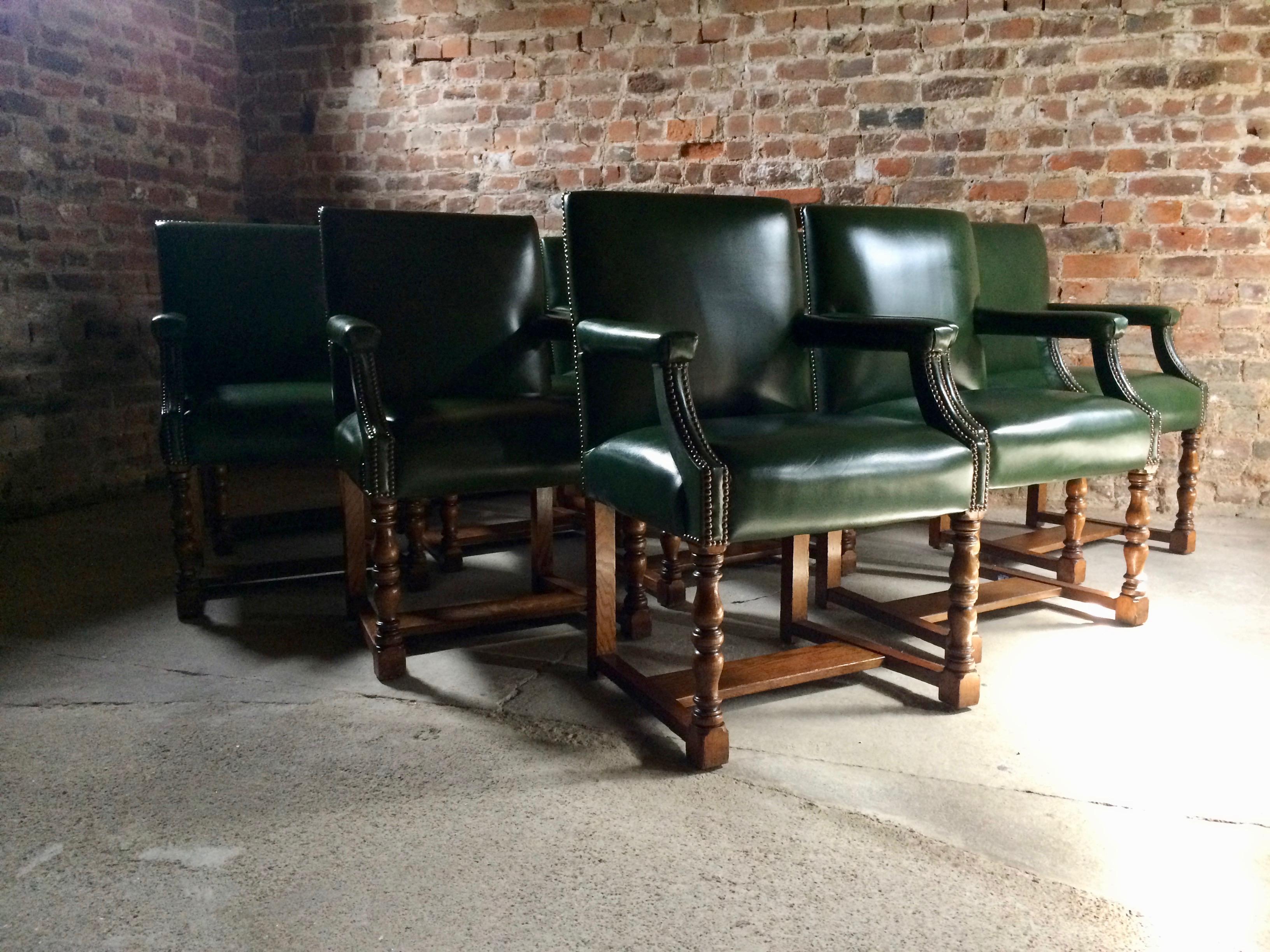 A magnificent and very rare set of Eleven Howard & Sons solid oak Gainsborough library or boardroom chairs dating to circa 1890, the chairs have recently been re upholstered in the finest deep bottle green leather with brass stud bound work, raised