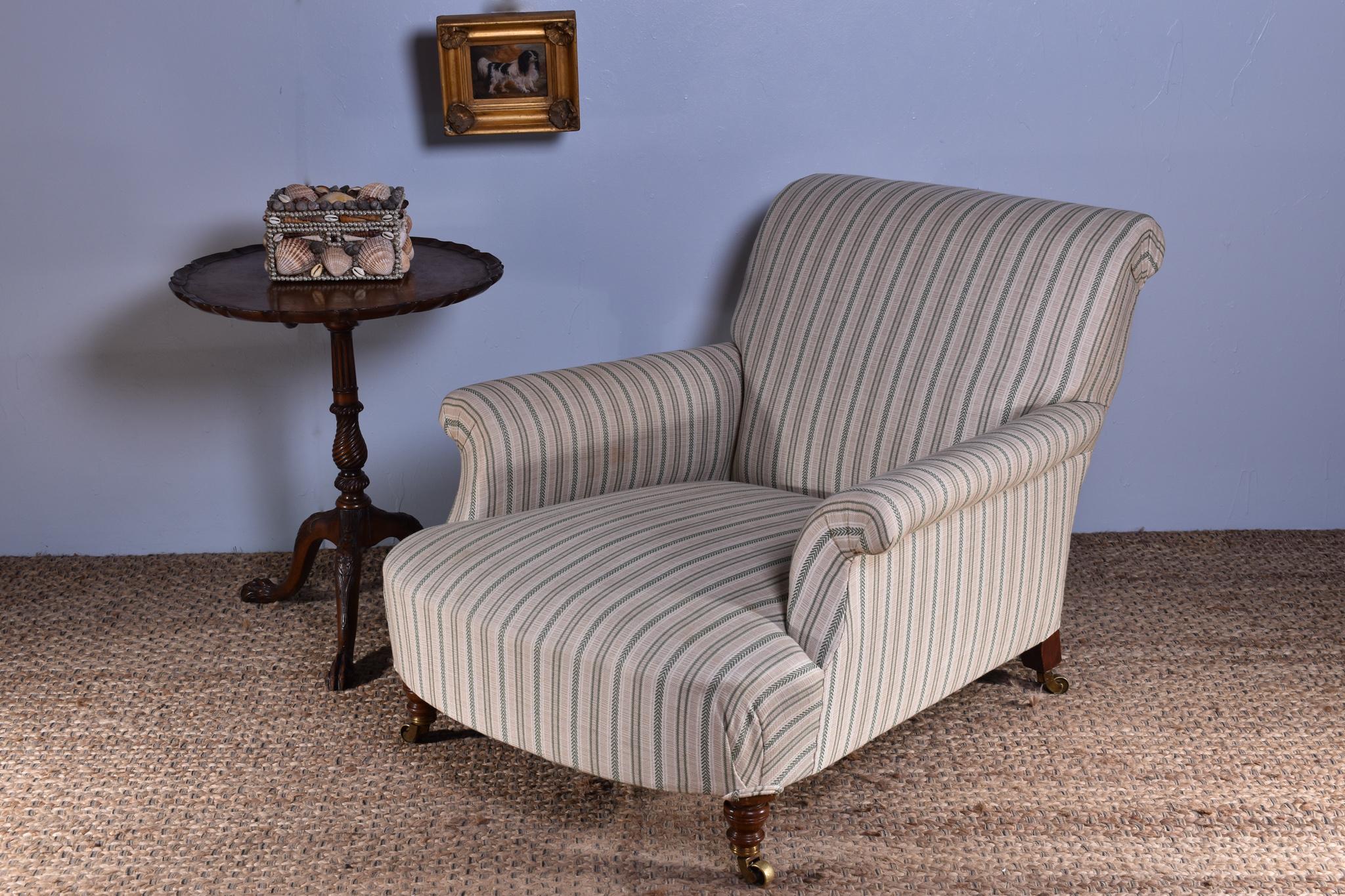 A large, deep seated club armchair by Howard & Sons, with exceptional form and comfort. C.1890

Raised on turned walnut forelegs with the rear splayed back left leg bearing the company stamp, all of the original brass casters are present and also