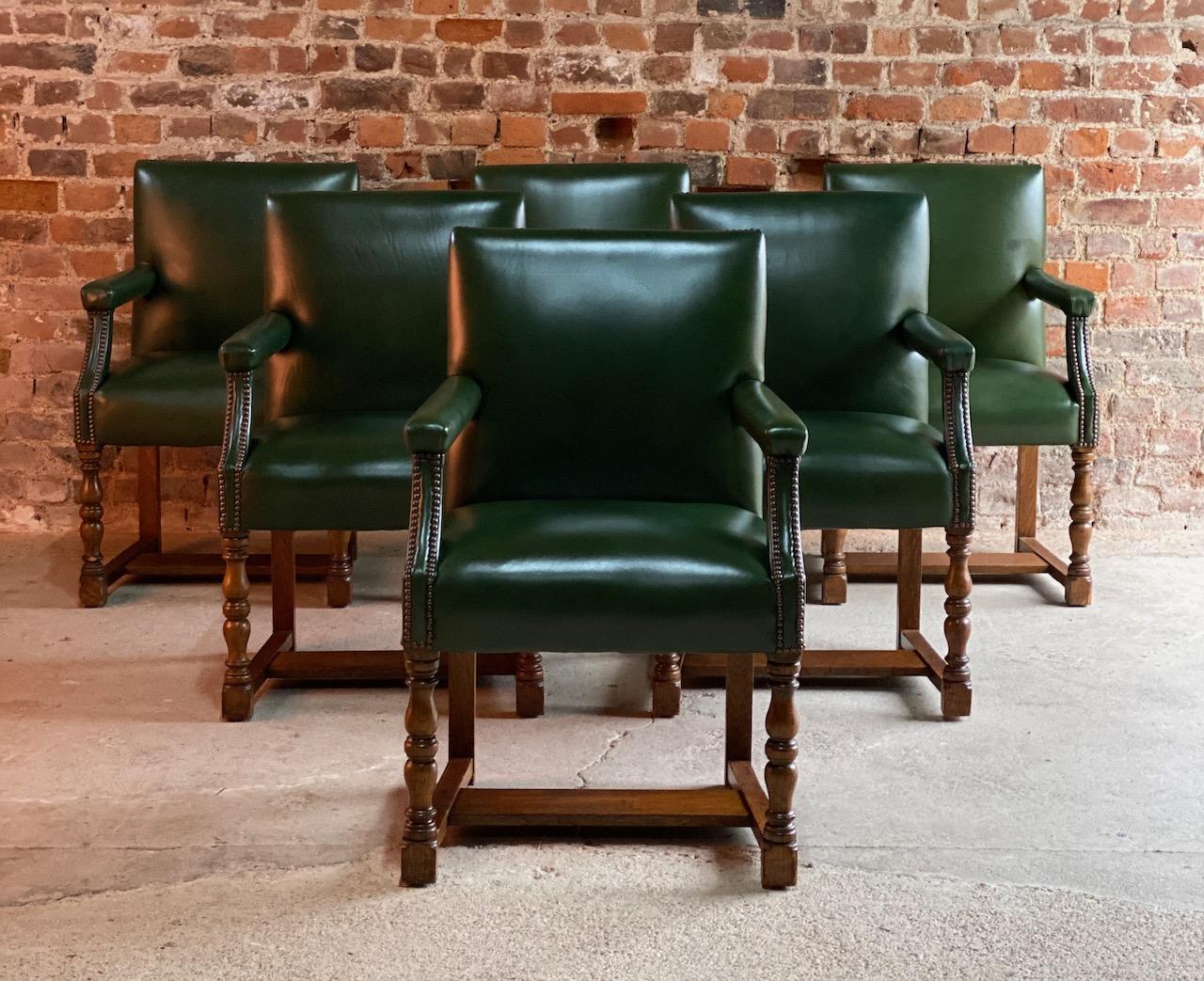 Howard & Sons set of six solid oak Gainsborough library or boardroom chairs dating to circa 1890, the chairs have recently been re upholstered in the finest deep bottle green leather with brass stud bound work, raised on turned legs, joined by H