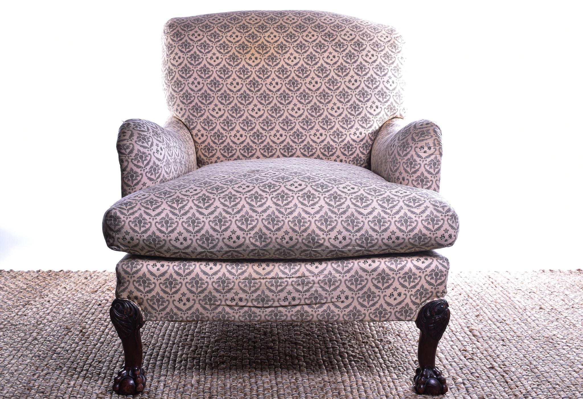 A Tremendous Late 19th Century deep-seated Howard & Sons Ivor Armchair, covered in original ticking, with squab cushion and plain seat rail, on shell-carved and acanthus cabriole forelegs with ball and claw feet, the rear leg stamped Howard & Sons