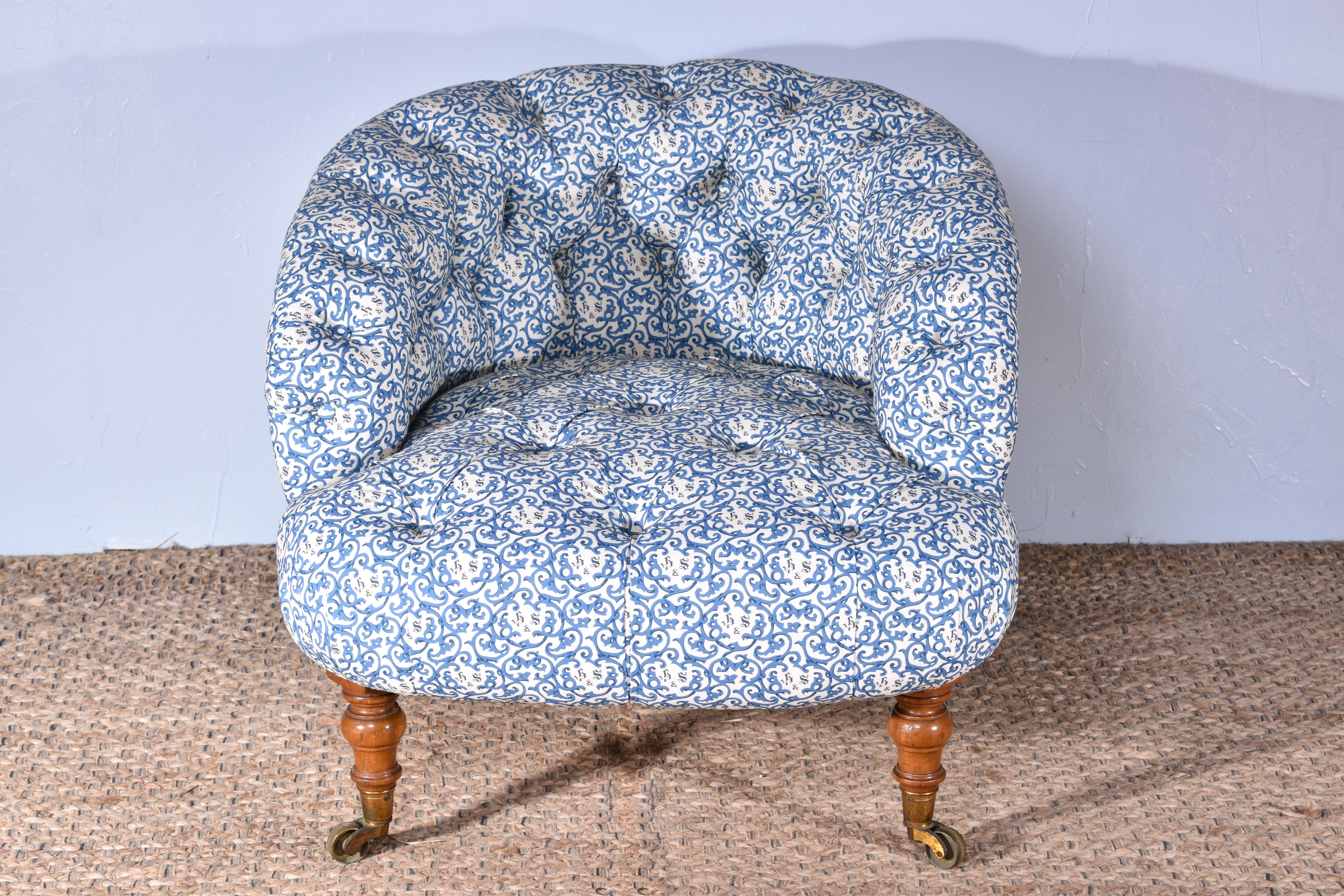 A delightful early Howard & Sons tub chair. C.1850.

Professionally and traditionally upholstered in a blue Howard and Sons cotton fabric, the exact specification of the original found on the chair.

Featuring a deep buttoned backrest, arms and